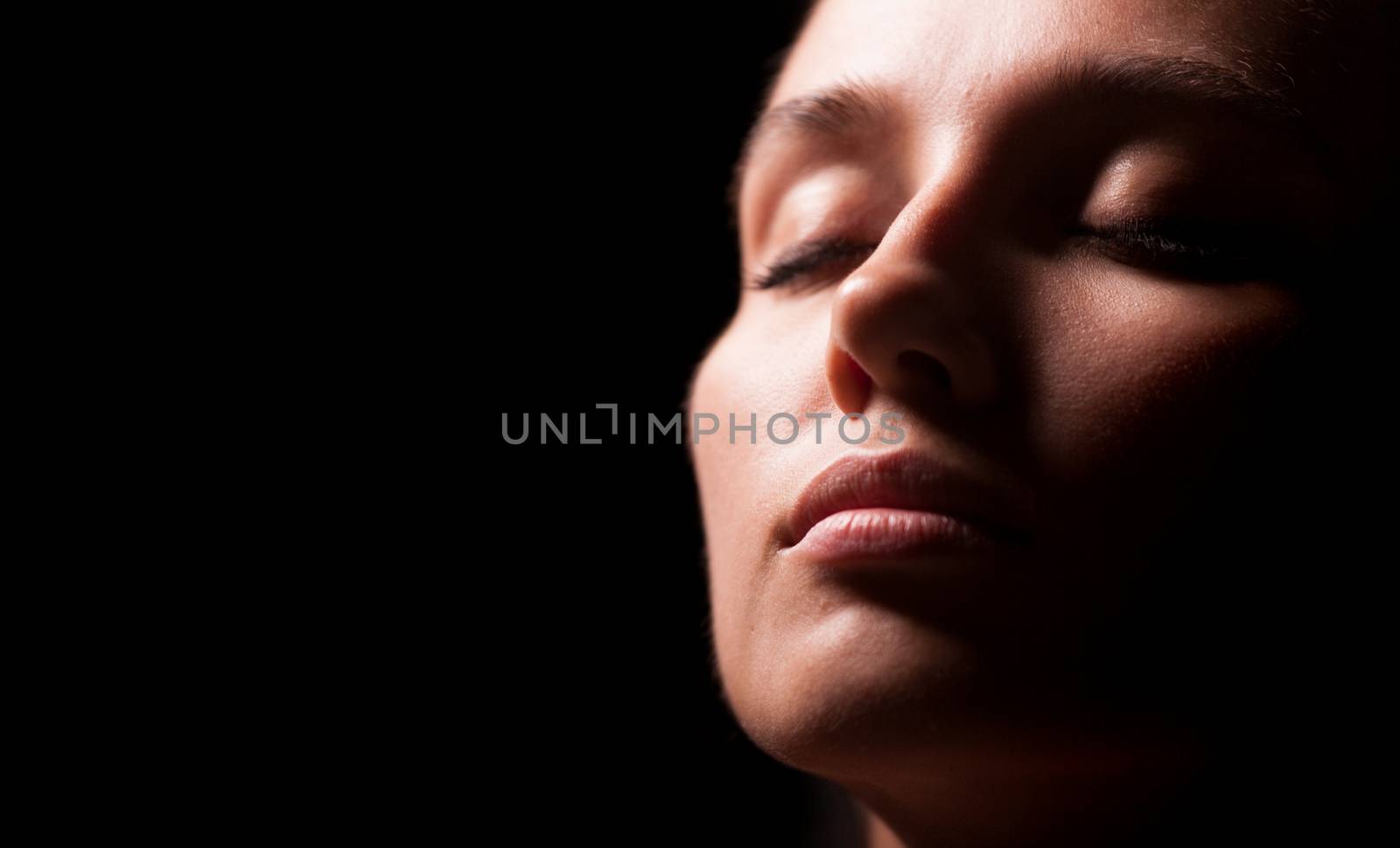 Portrait of a woman on black background