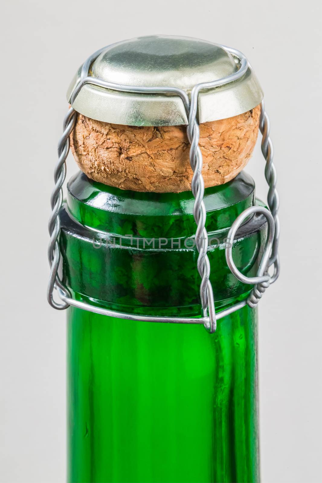 Top of champagne bottle on a white background