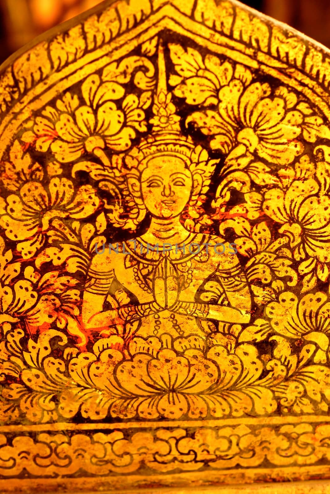 detail of traditional thai pattern that made by stitched gold leaf on wood plate,shallow focus