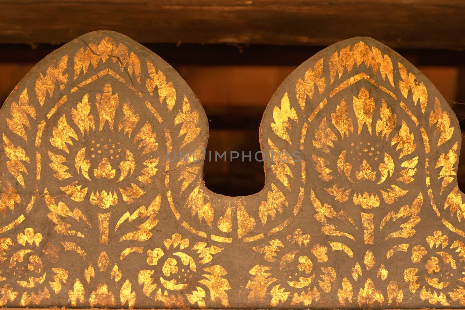 the detail of  thai gold painting pattern on ancient  wood plate,shallow focus,Lampang temple,Thailand