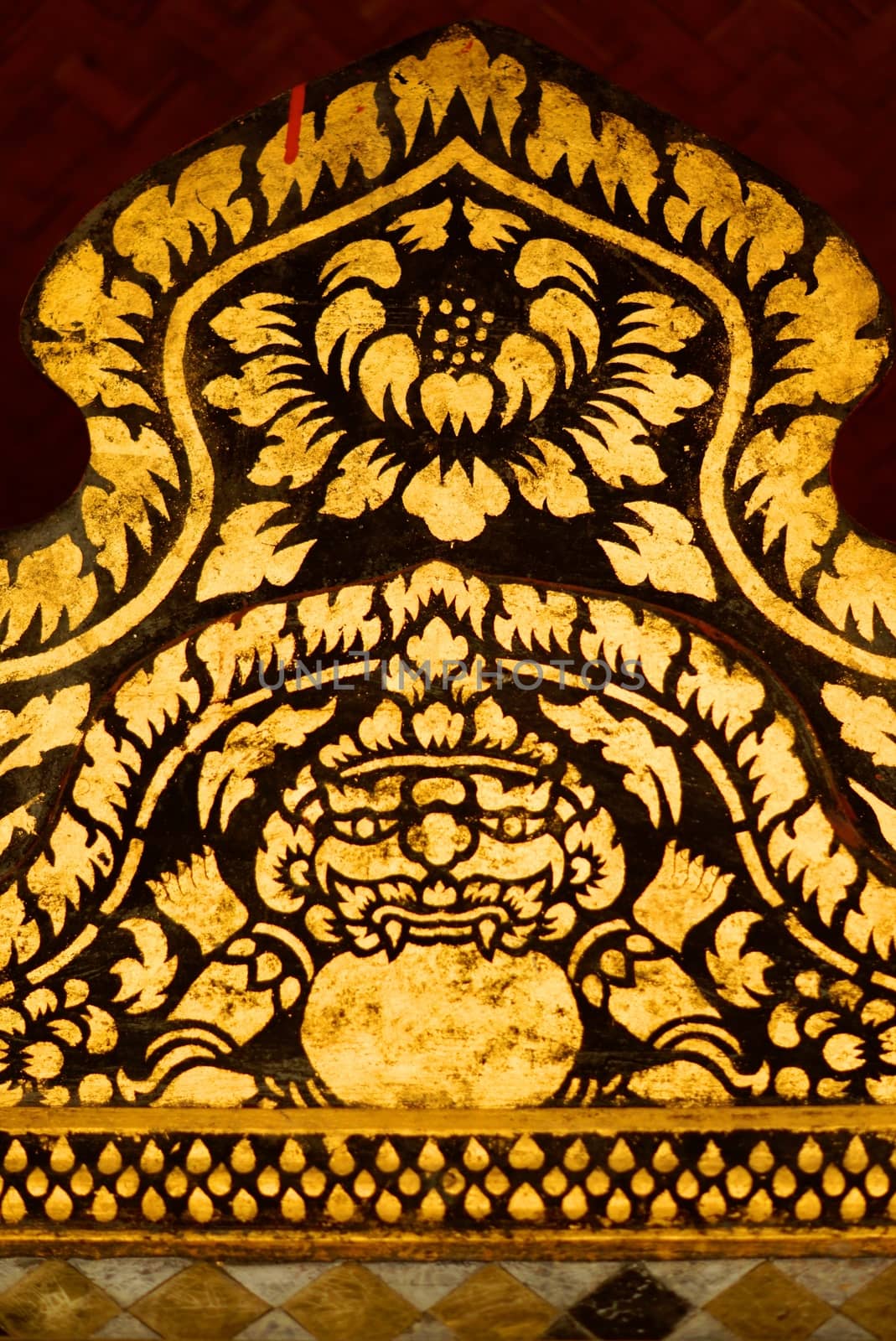 the detail of  thai gold painting pattern on ancient  wood plate,shallow focus,Lampang temple,Thailand