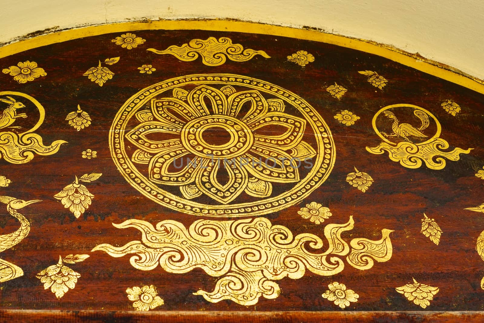 the detail of  thai gold painting pattern on ancient  wood plate,shallow focus,Lampang temple,Thailand