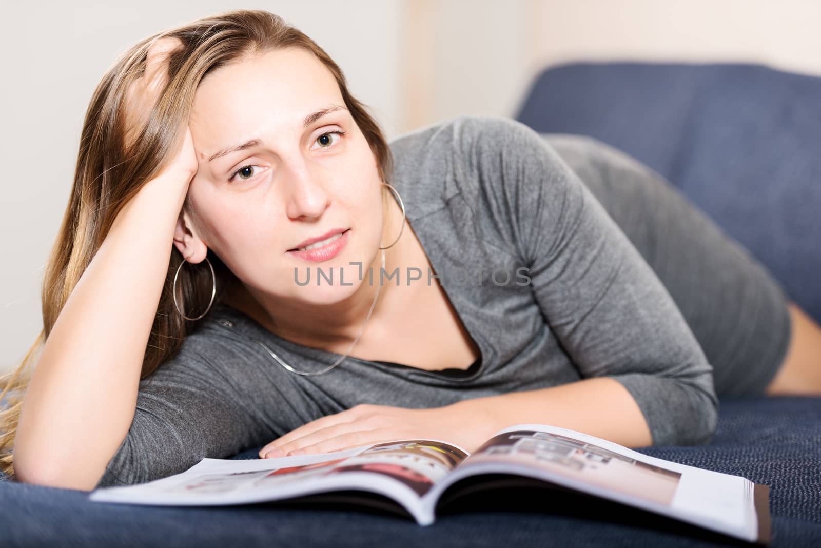 Brunette reading magazine horizontal by Nanisimova