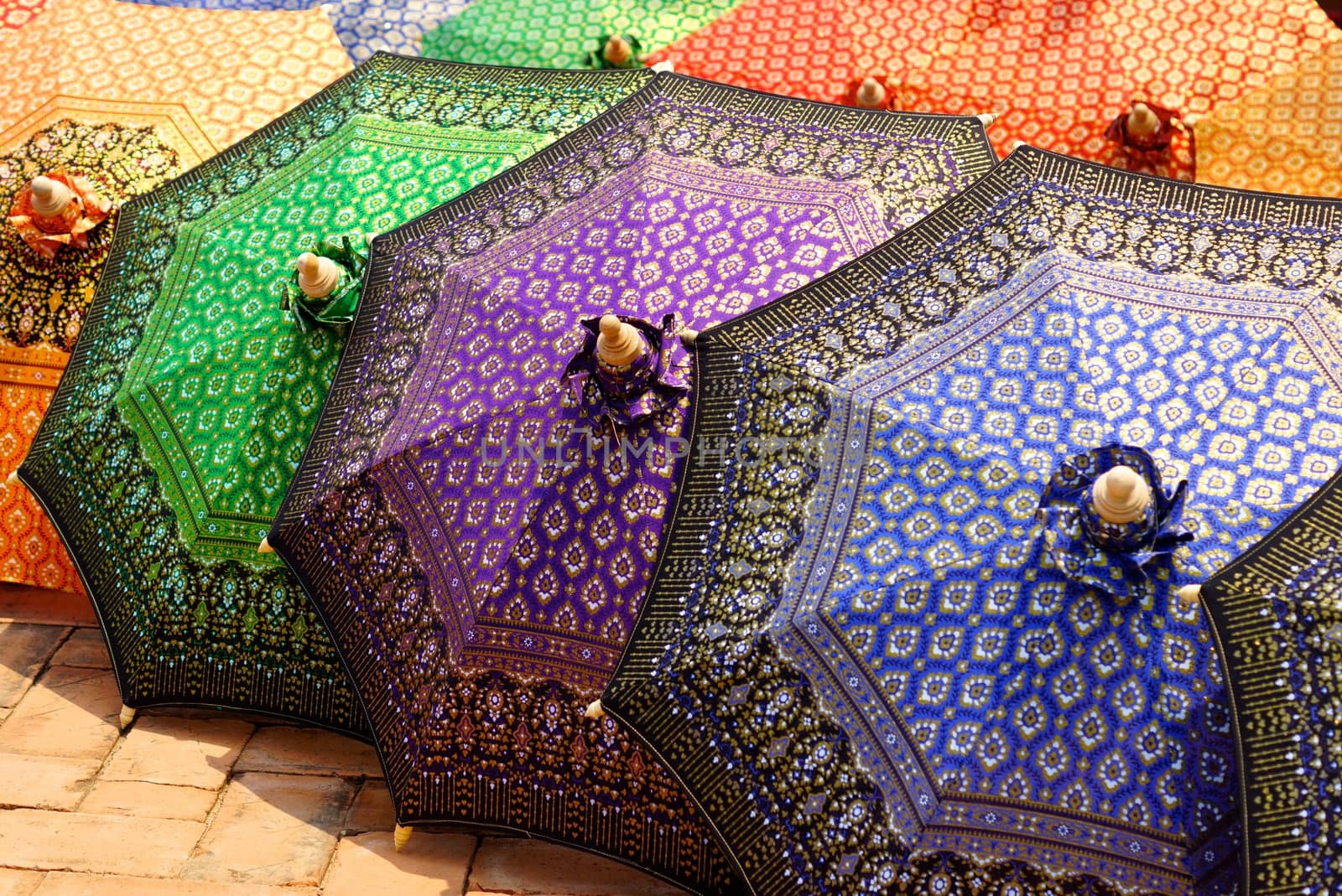 detail of thai traditional painted umbrella that made by silk fabric and wood structure with thai  pattern painting,shallow focus