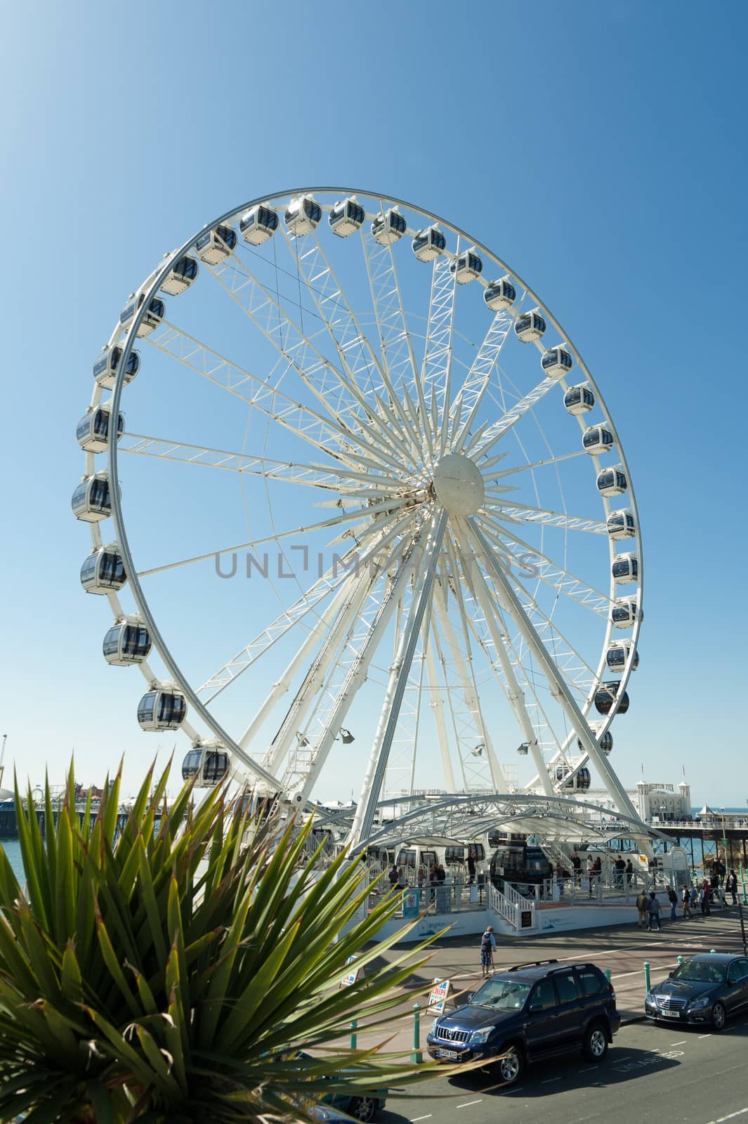 BRIGHTON, UK - APRIL 2, 2012: Clear blue sky over the Brighton Wheel and historic Pier in Brighton, UK