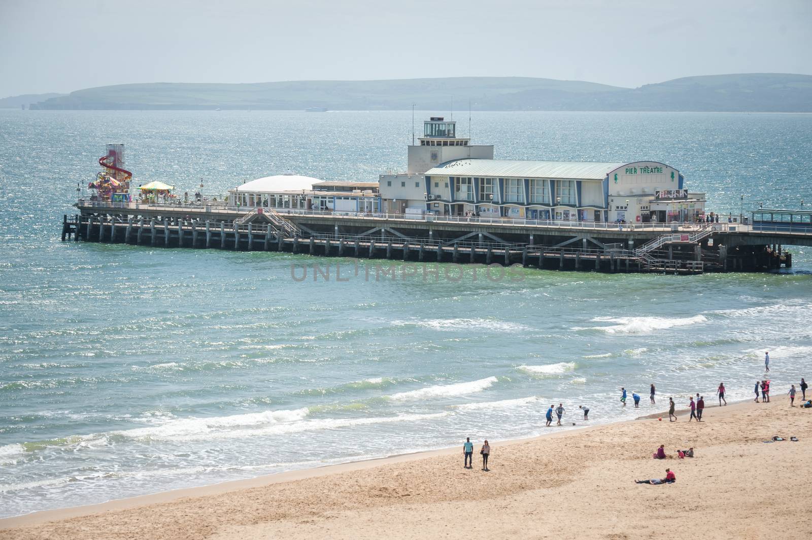 BOURNEMOUTH, UK - JUNE 14, 2013: Originally constructed in the 19th century, the pier remains one of the most popular tourist attractions of its type in Britain