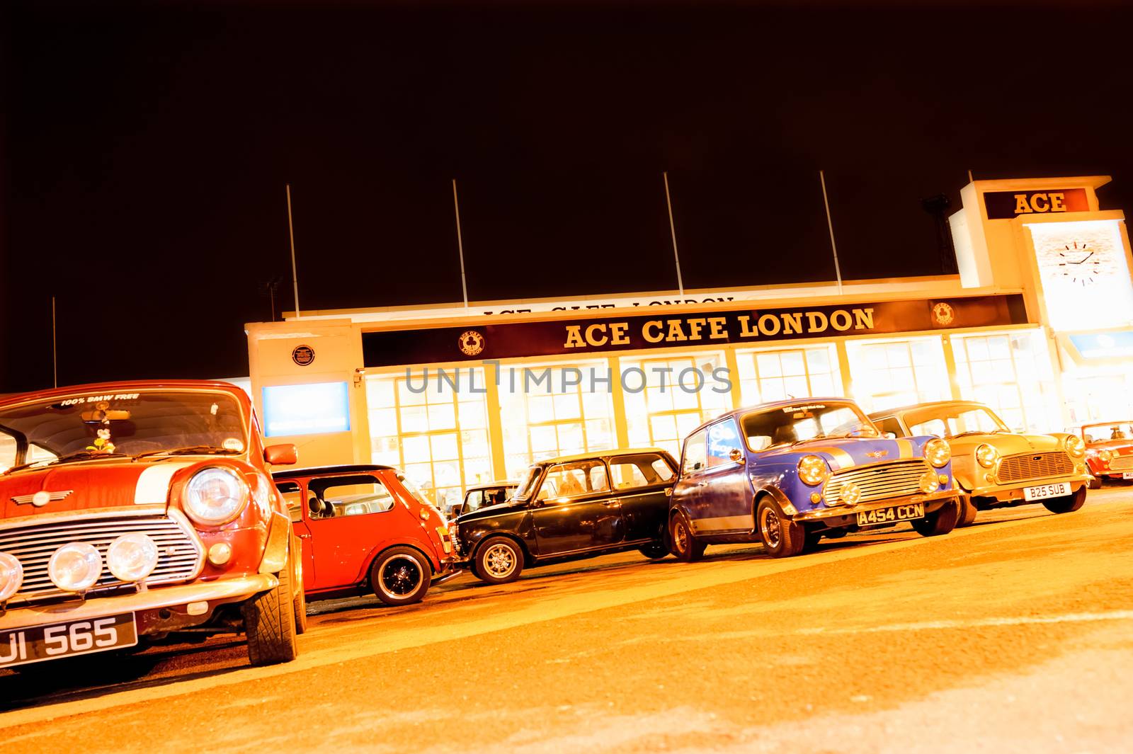 London, UK - April 4, 2013: Night exposure of classic Austin Mini automobiles parked at the landmark Ace Cafe in London