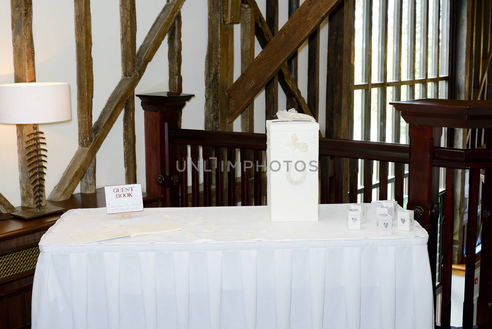Wedding reception gift table table decorated with guest book and confetti boxes