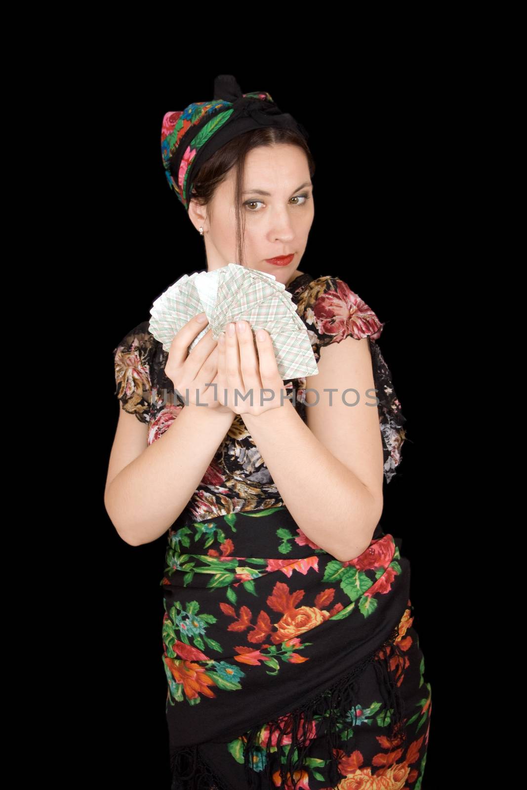 Gypsy woman with cards in hand on black background