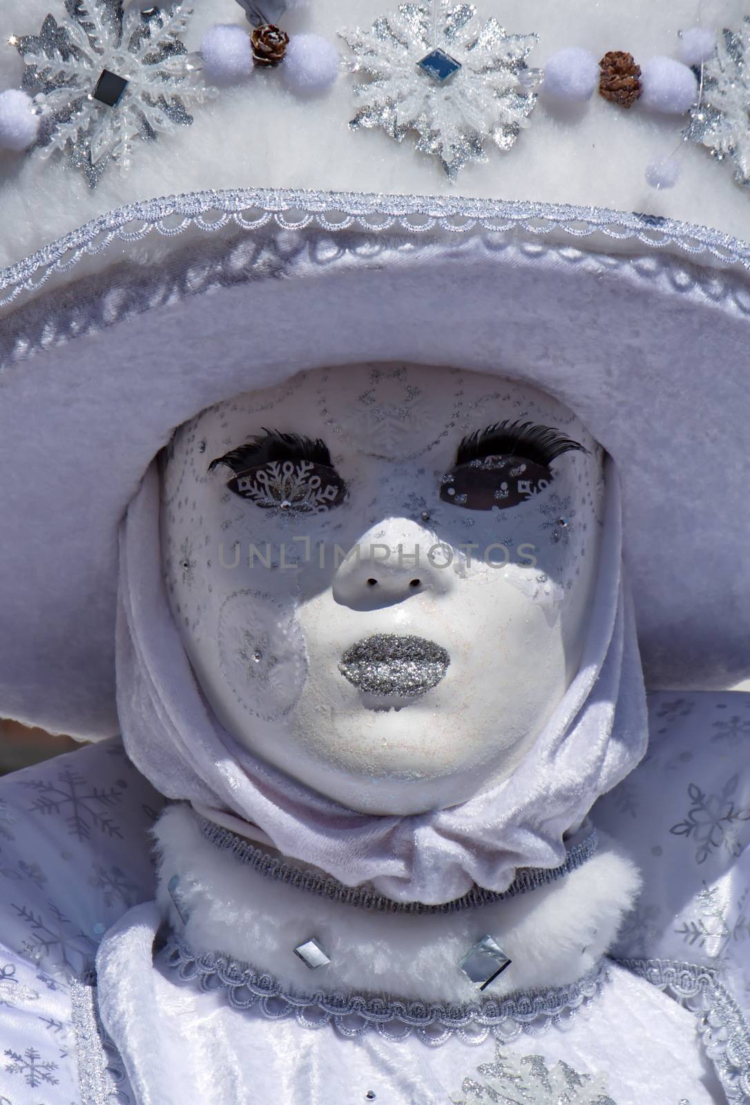 Close up on white mask and big hat at the 2014 venetian carnival of Annecy, France