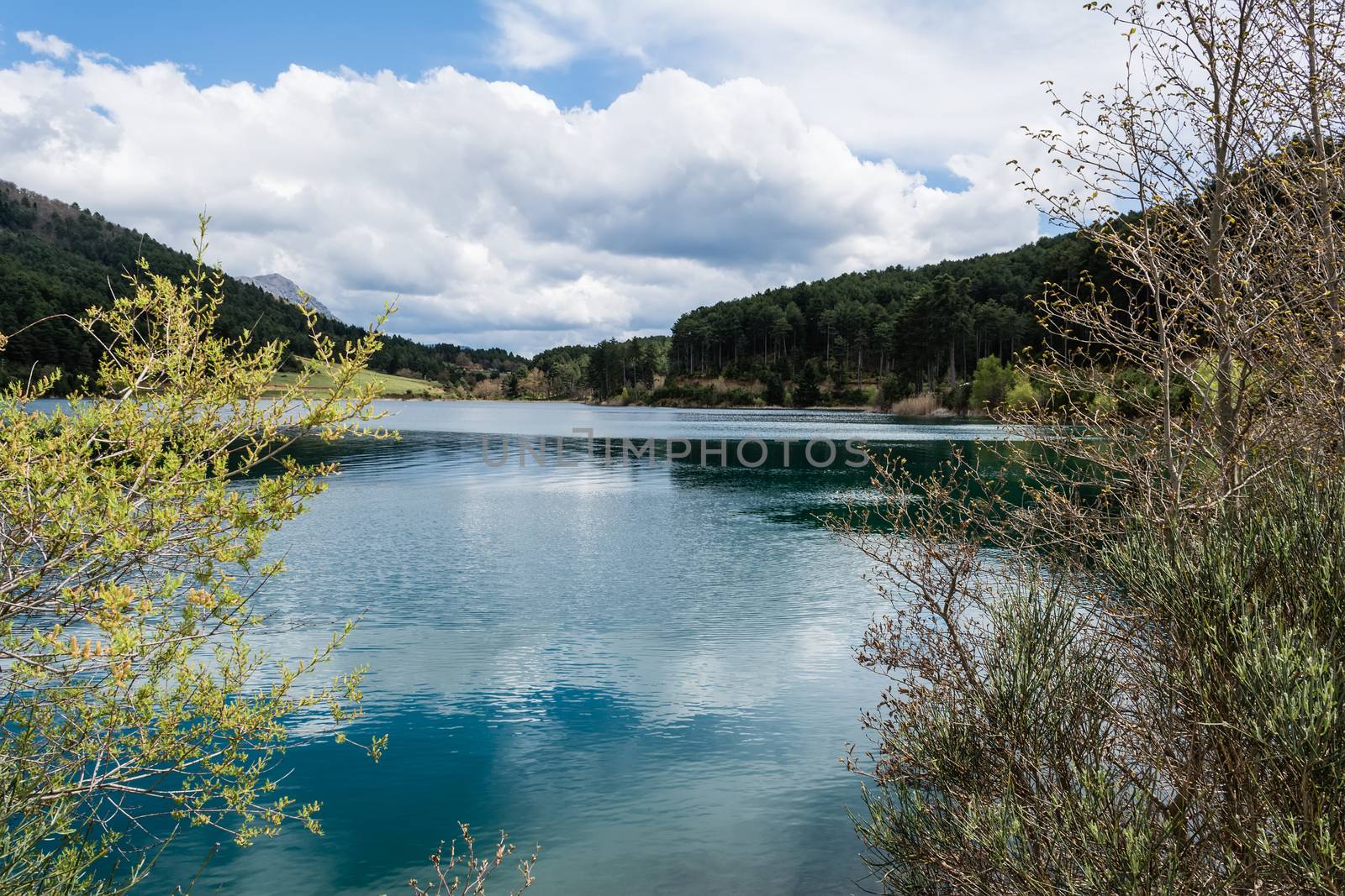 A blue lake under a cloudy sky - landscape.