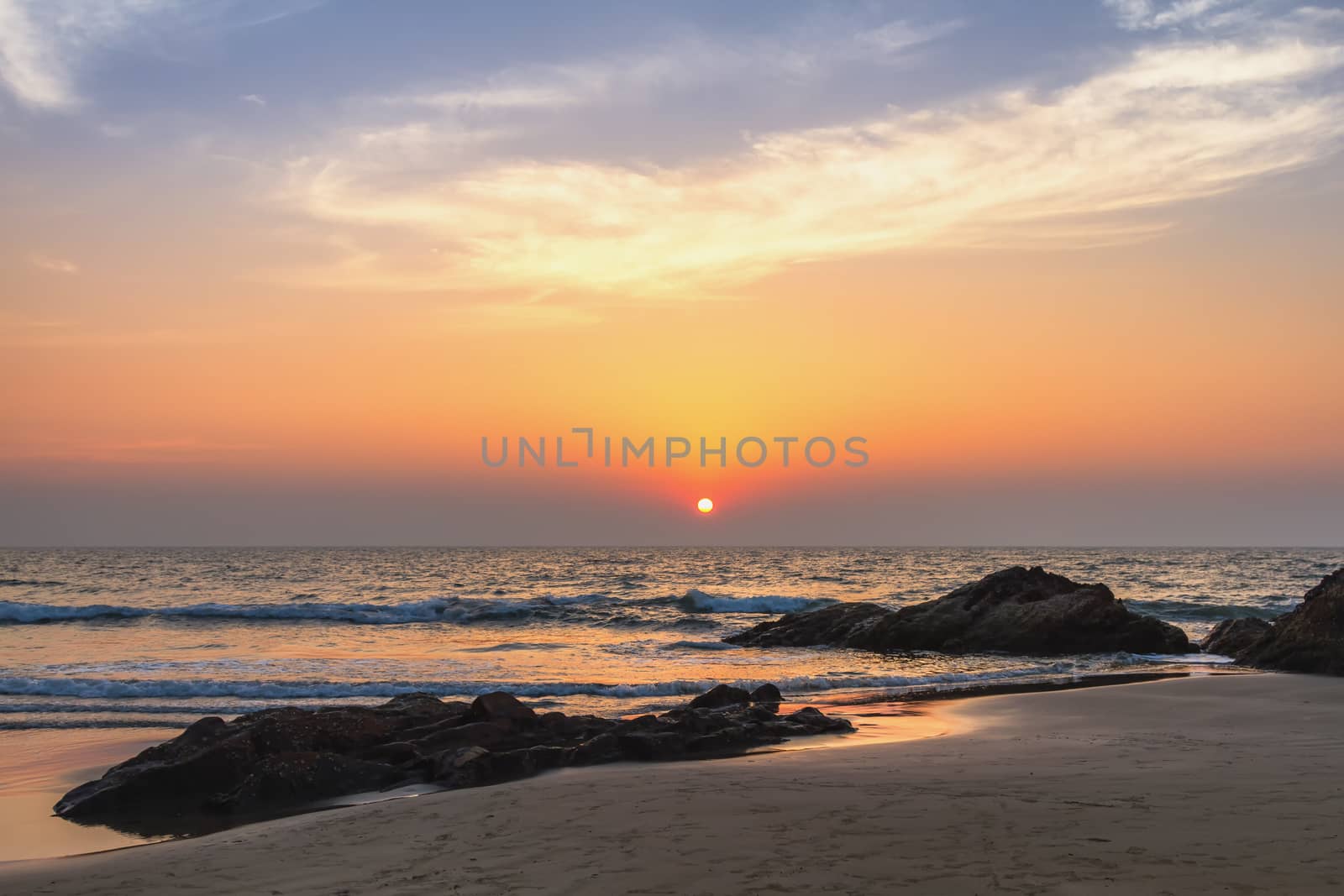 Scenic view from sand beach in Goa to beautiful sunset above the Arabian sea
