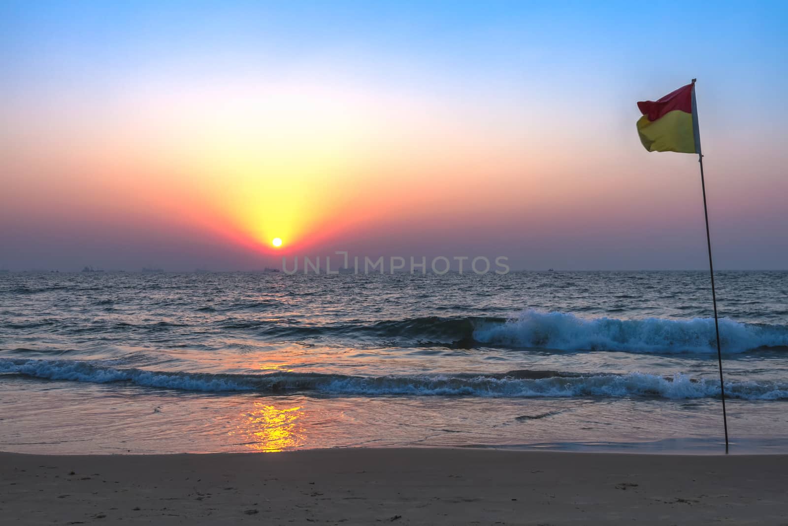 Scenic view from sand beach in Goa to beautiful sunset above the Arabian sea