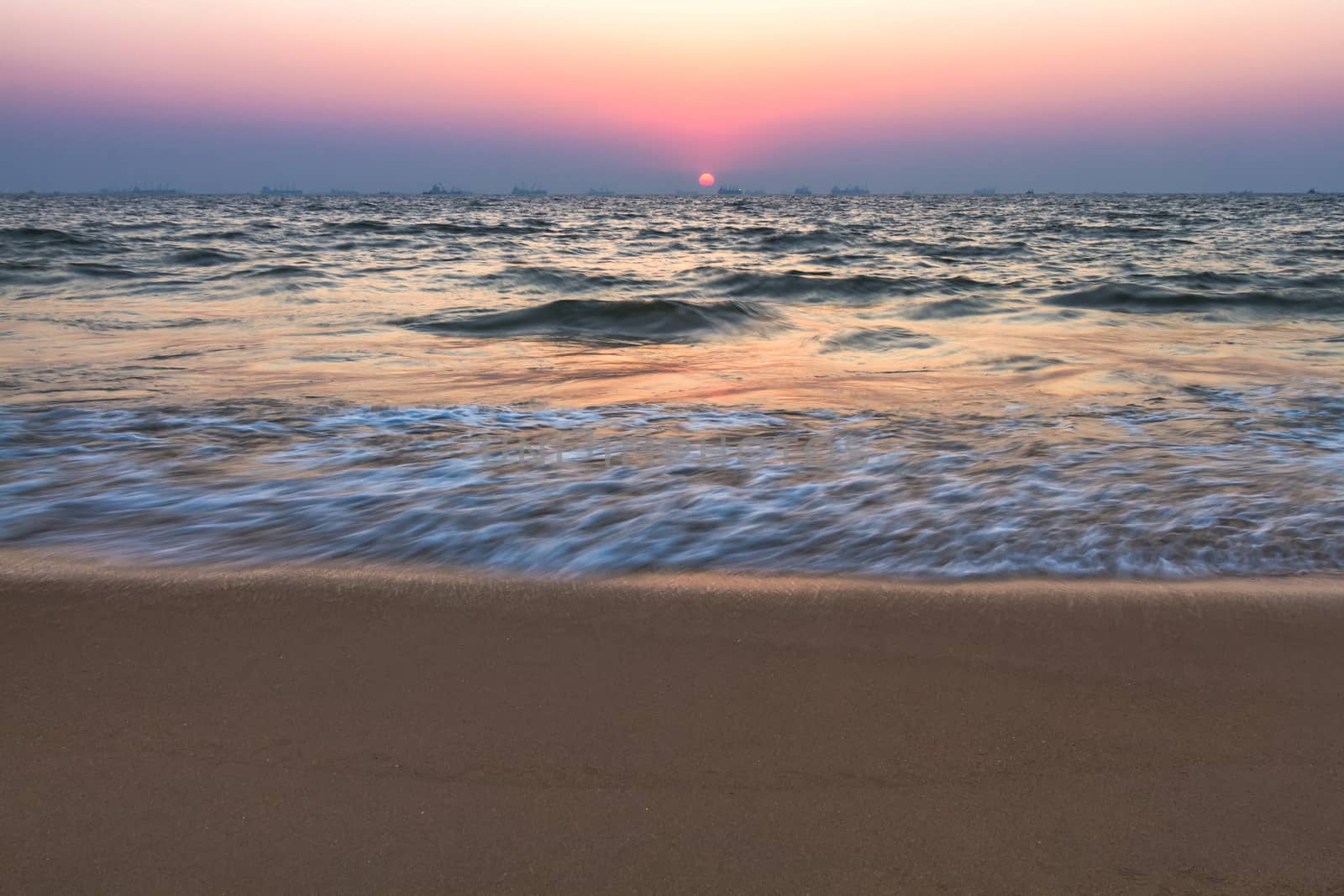 Scenic view from sand beach in Goa to beautiful sunset above the Arabian sea