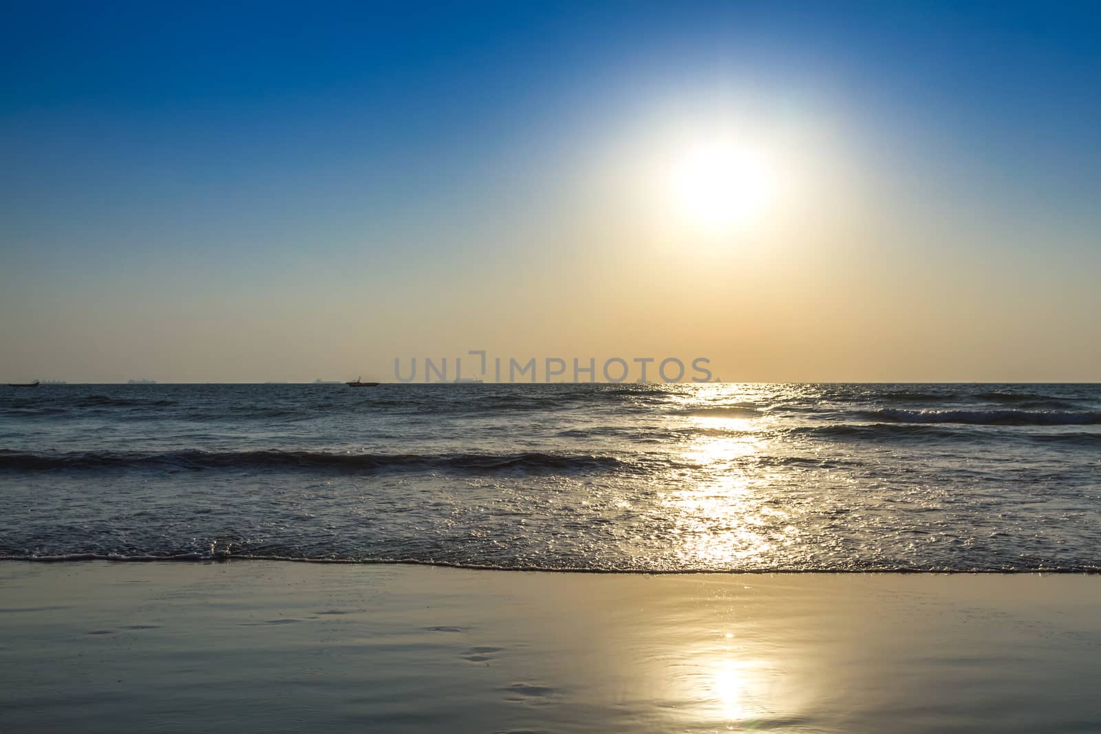 Scenic view from beach in Goa to beautiful sunrise above the Arabian sea. Sun reflection on sea surface