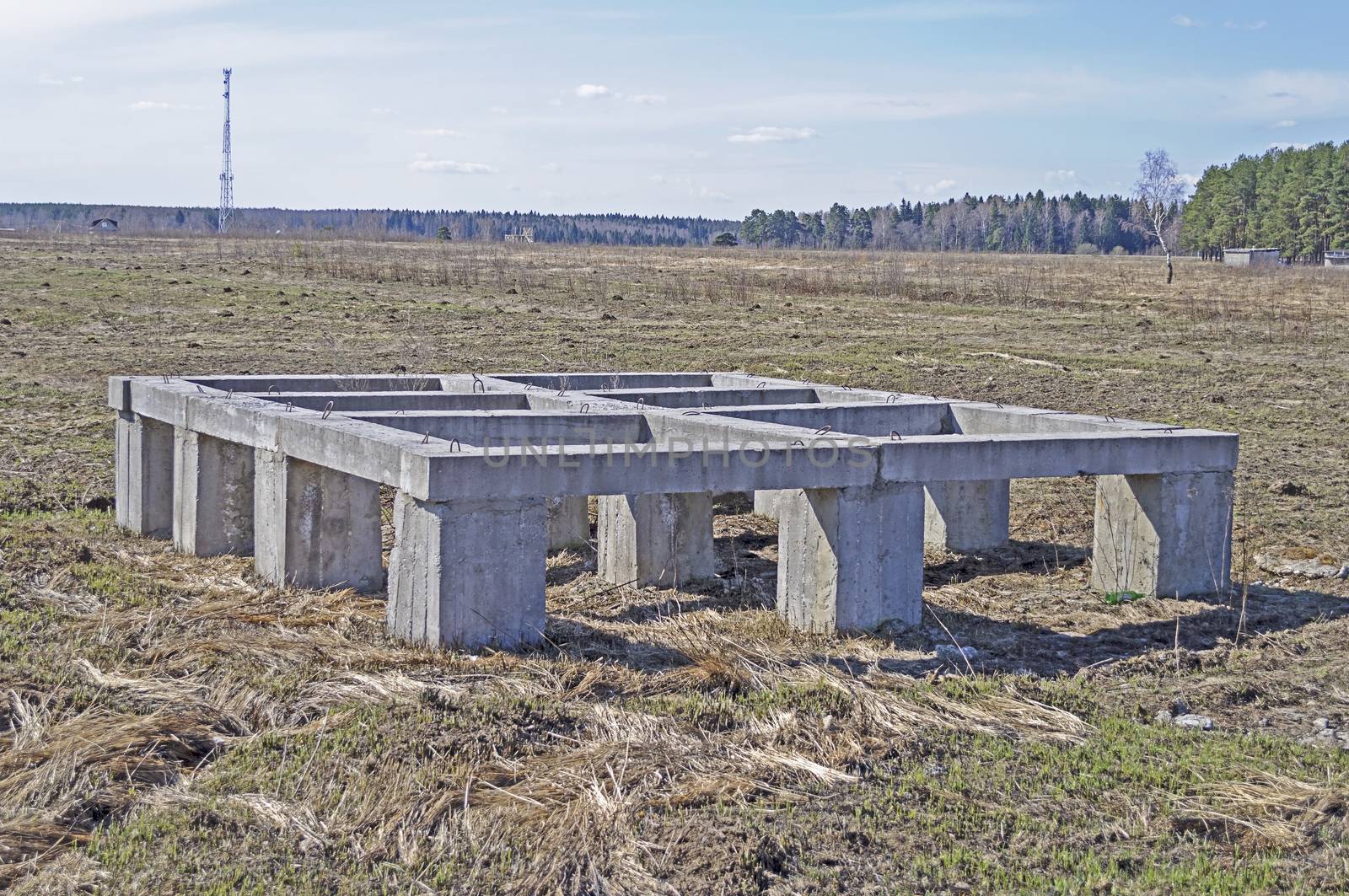 Pier foundation of small country house, spring time