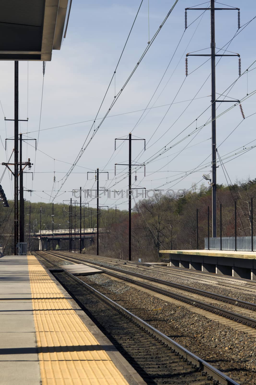 Empty electric rail road train tracks and platform