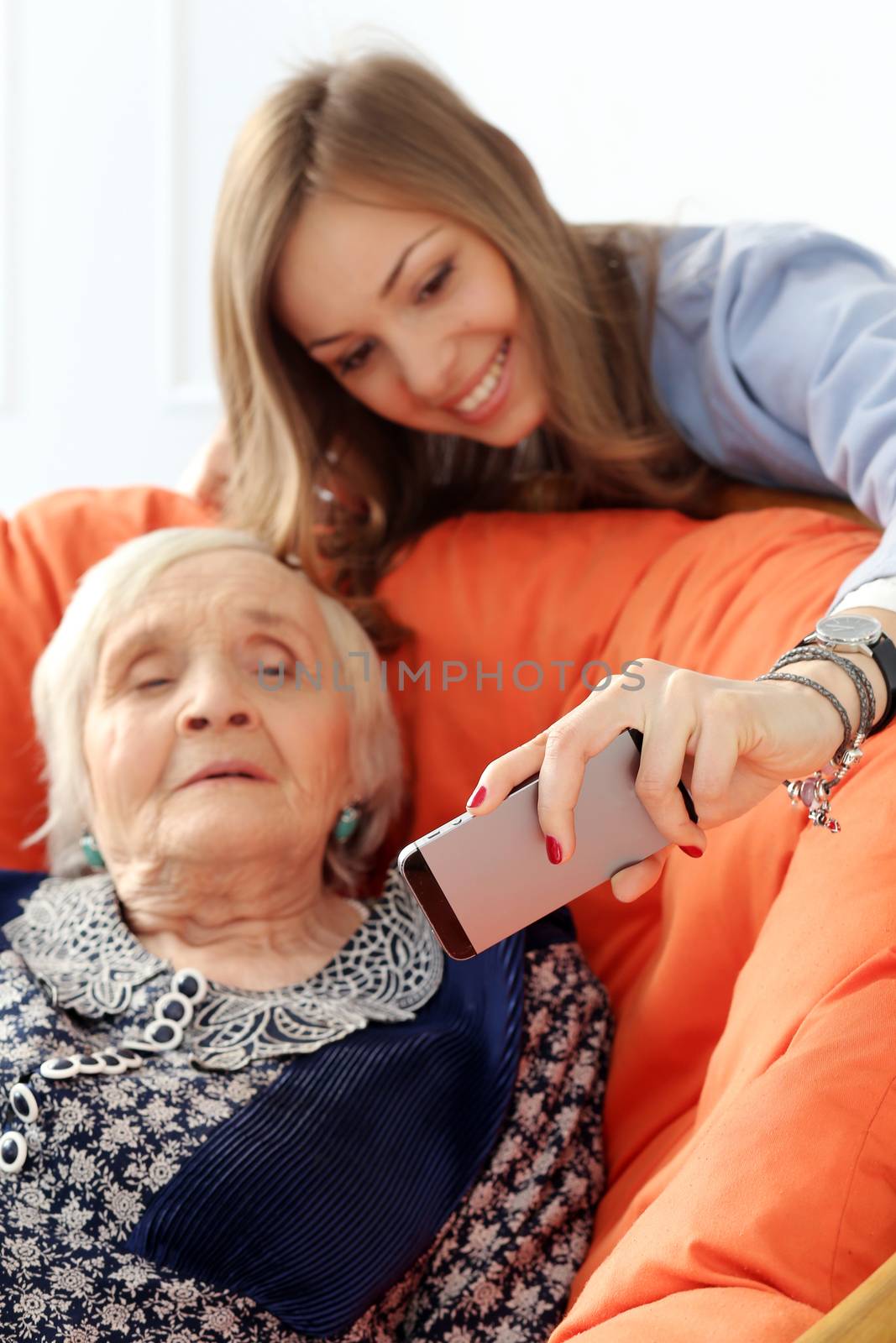 Elderly woman and beautiful granddaughter with wide smile