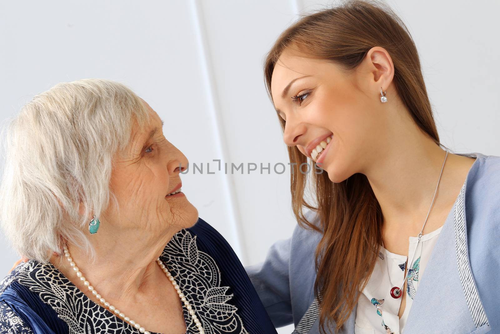 Close-up. Elderly woman and beautiful granddaughter with wide smile