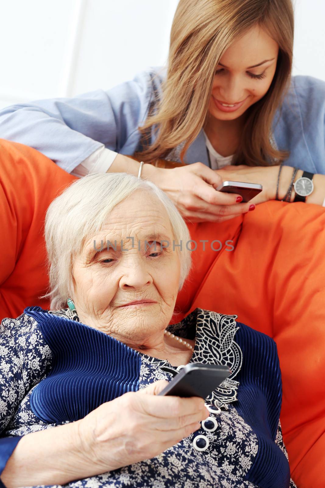 Elderly woman and beautiful granddaughter with wide smile