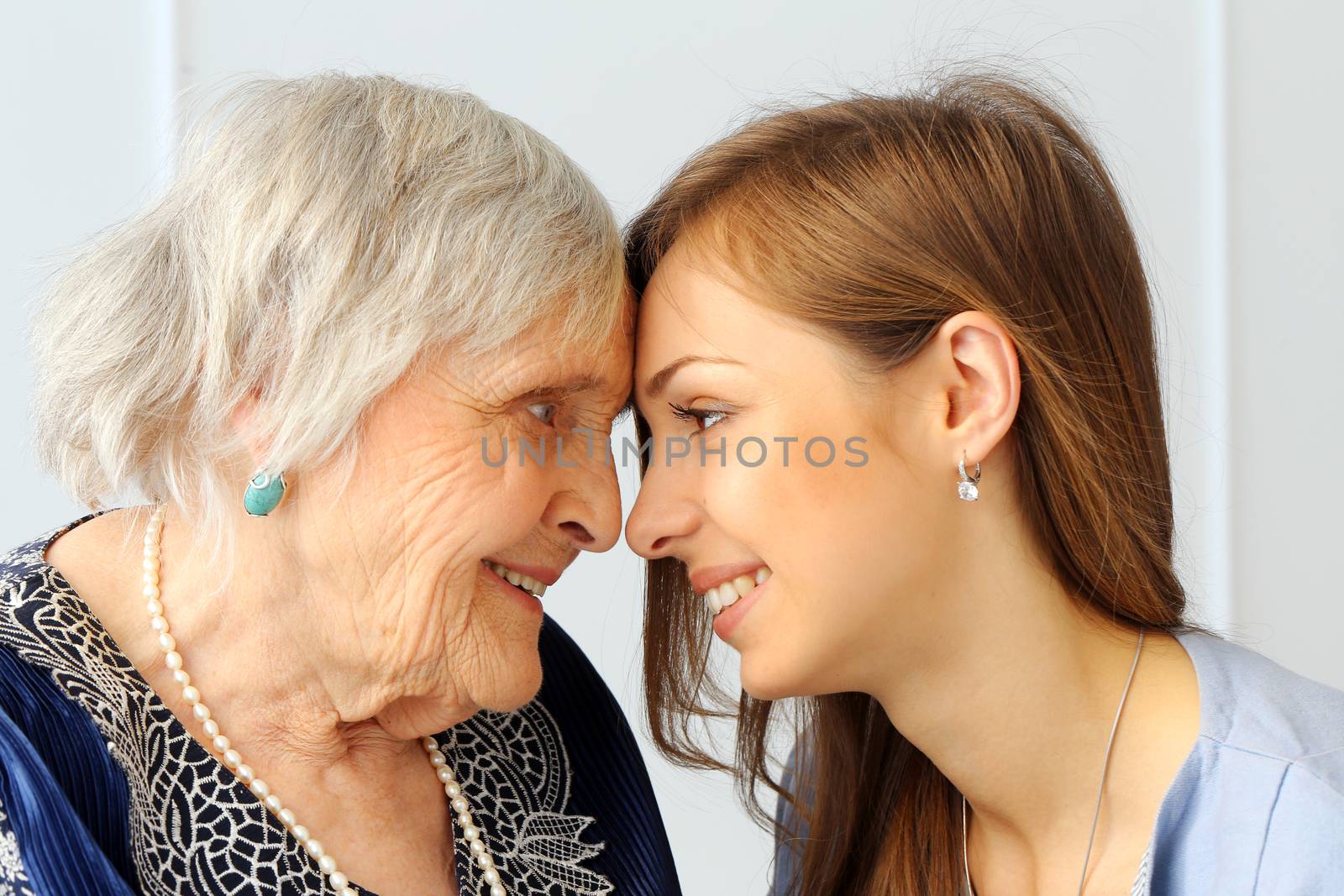 Close-up. Elderly woman and beautiful granddaughter with wide smile