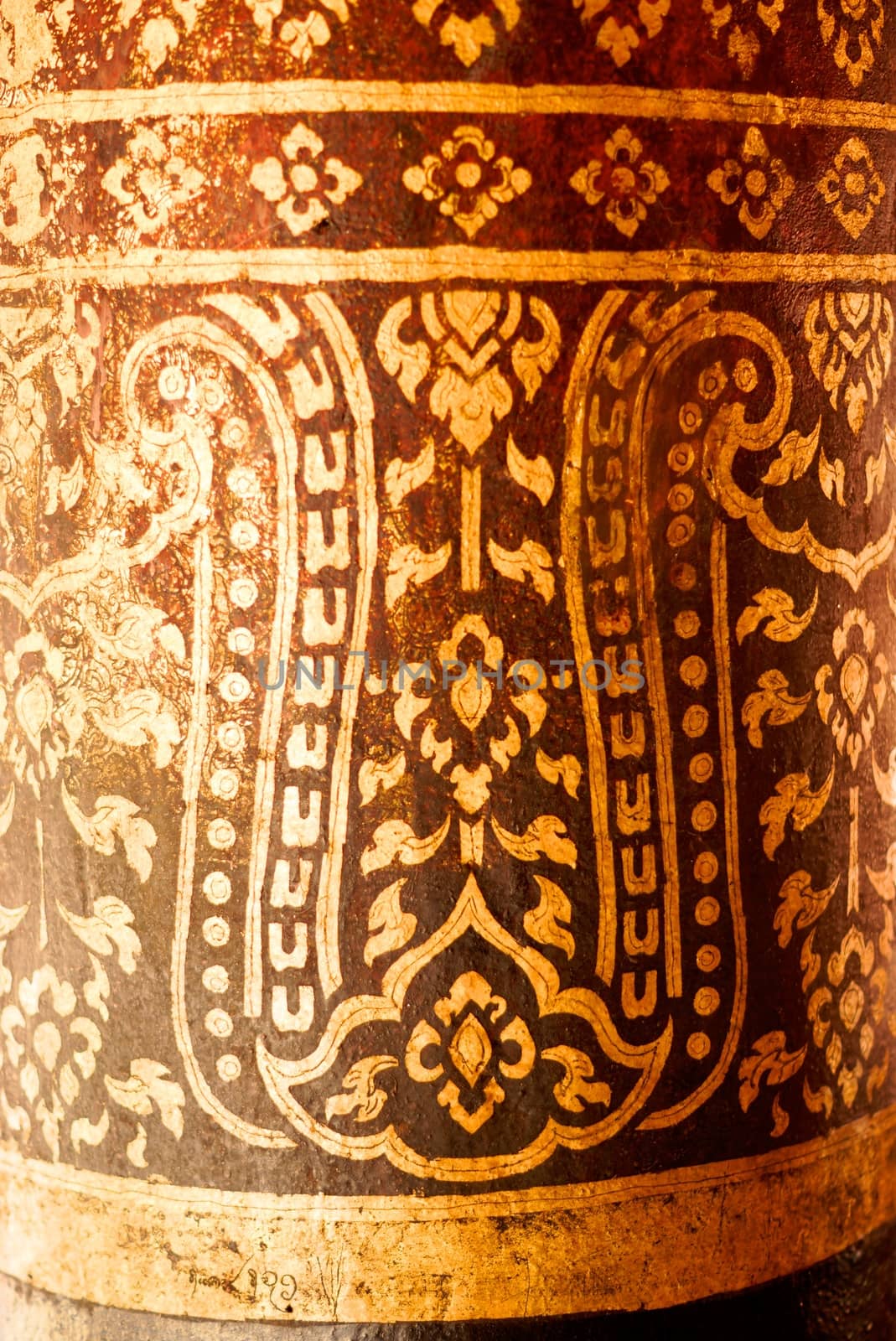 the detail of  thai gold painting pattern on ancient temple pillars ,shallow focus,Lampang temple,Thailand