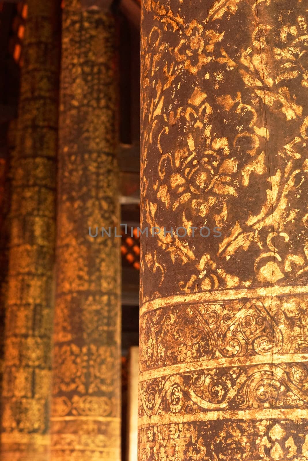 the detail of  thai gold painting pattern on ancient  wood temple pillar,shallow focus,Lampang temple,Thailand