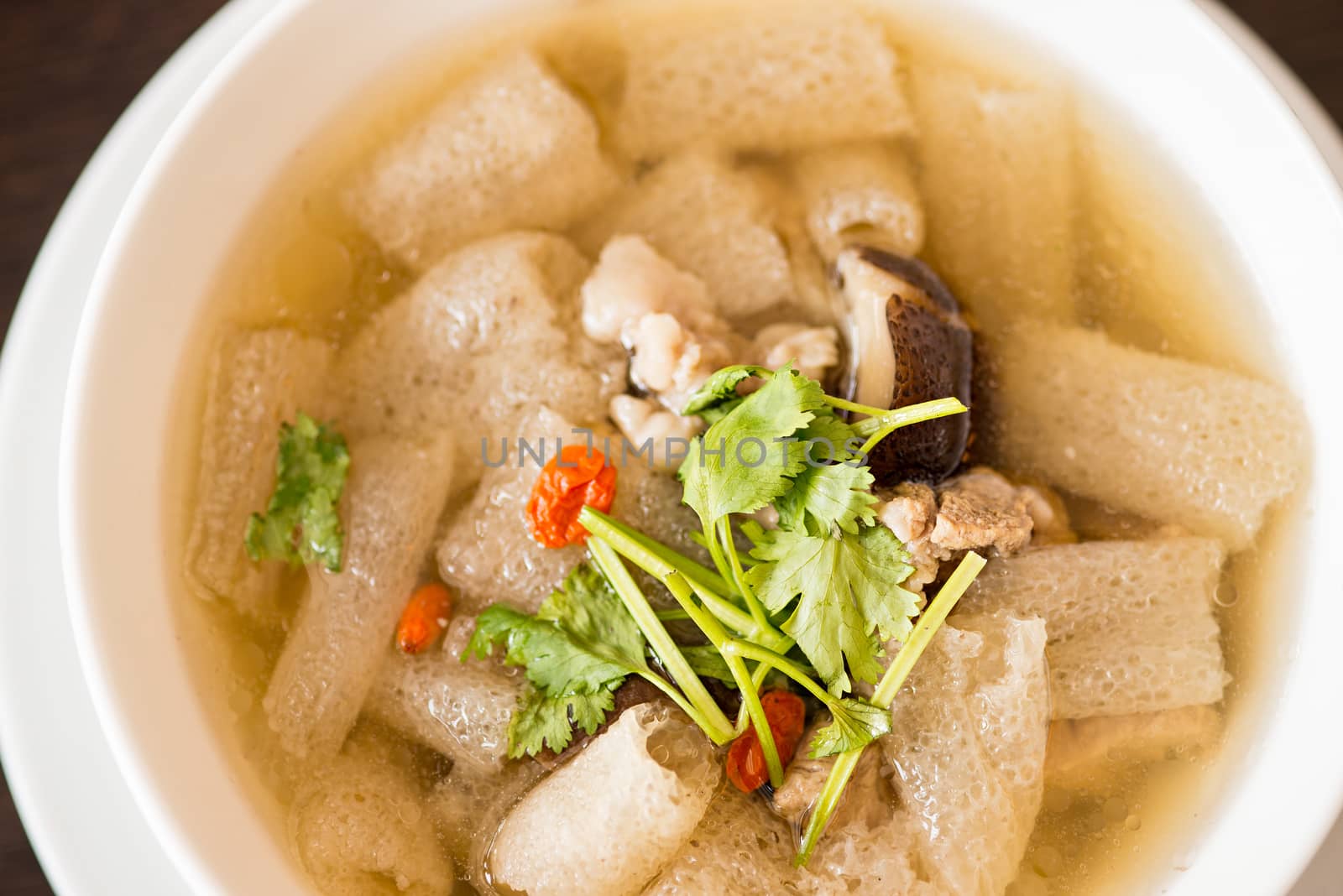 Braised Pork soup with Chinese herb and bamboo in white bowl