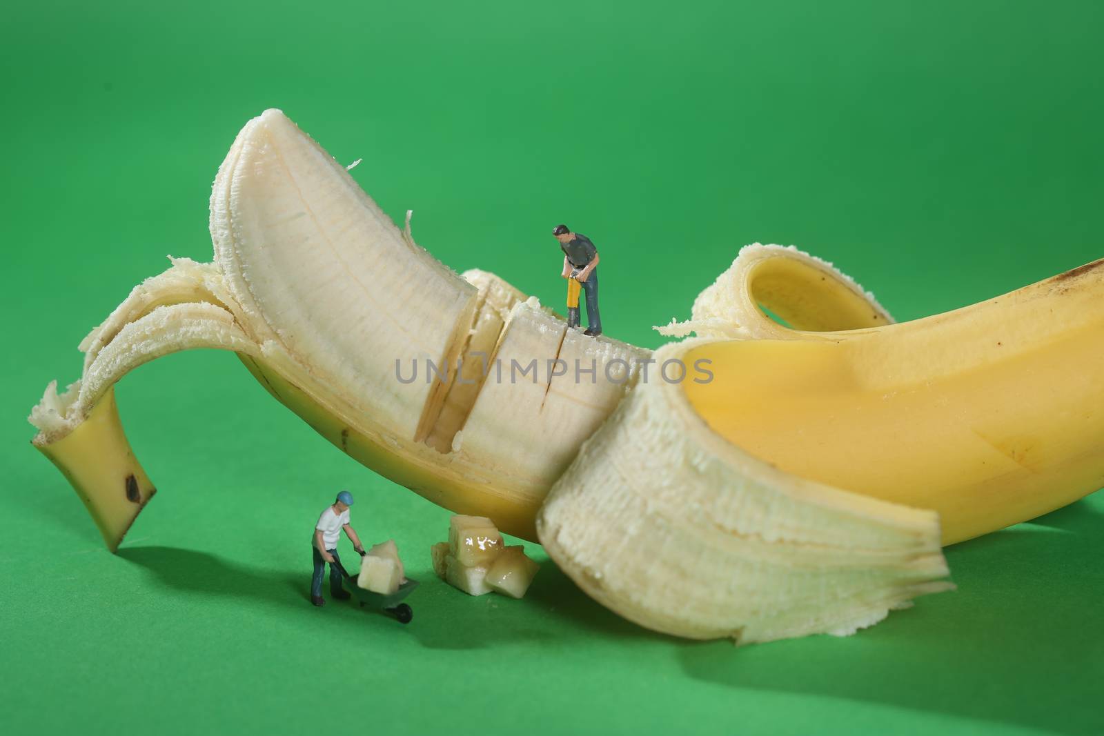 Miniature Construction Workers in Conceptual Food Imagery With Banana