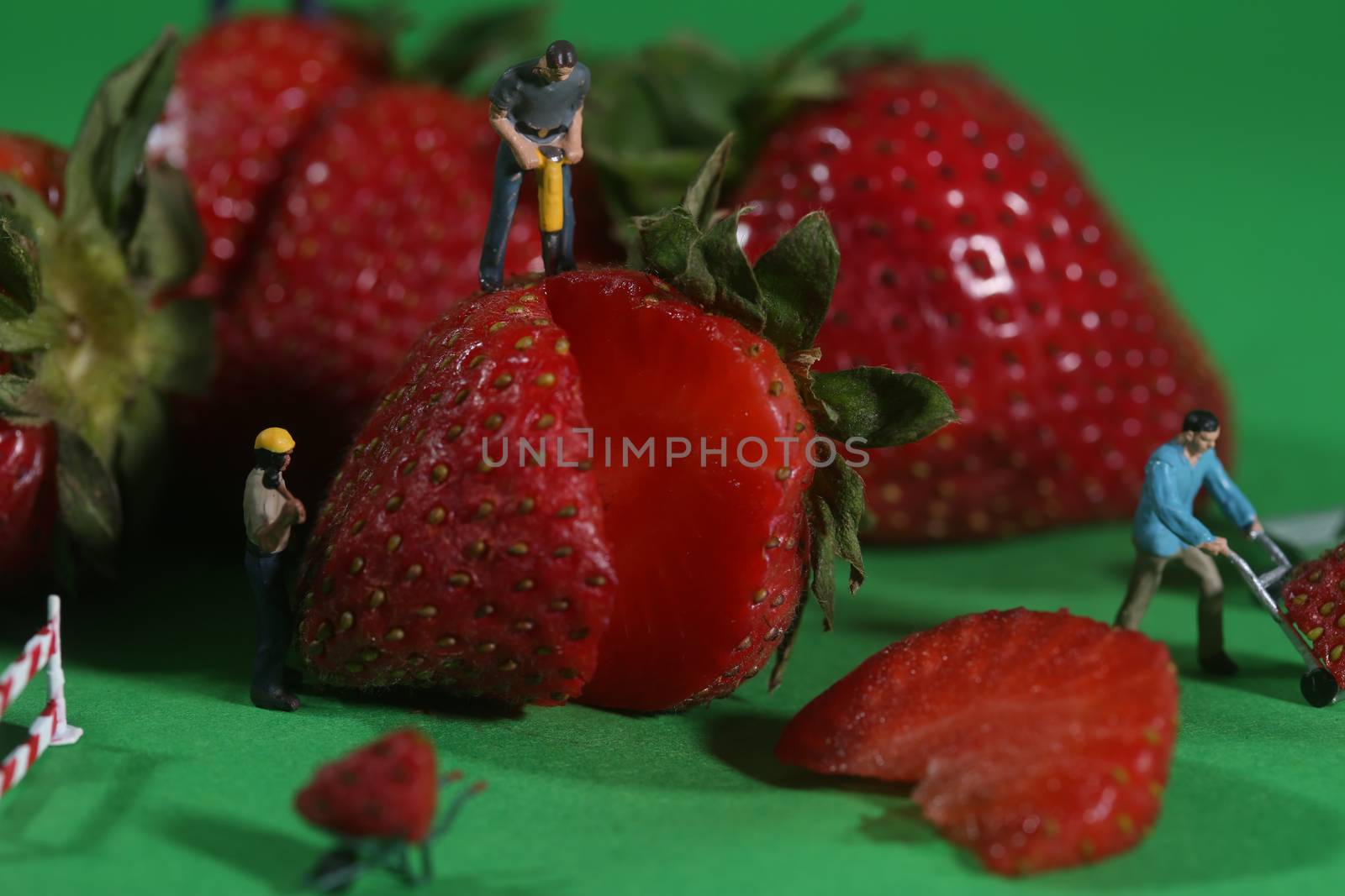 Miniature Construction Workers in Conceptual Food Imagery With Strawberries