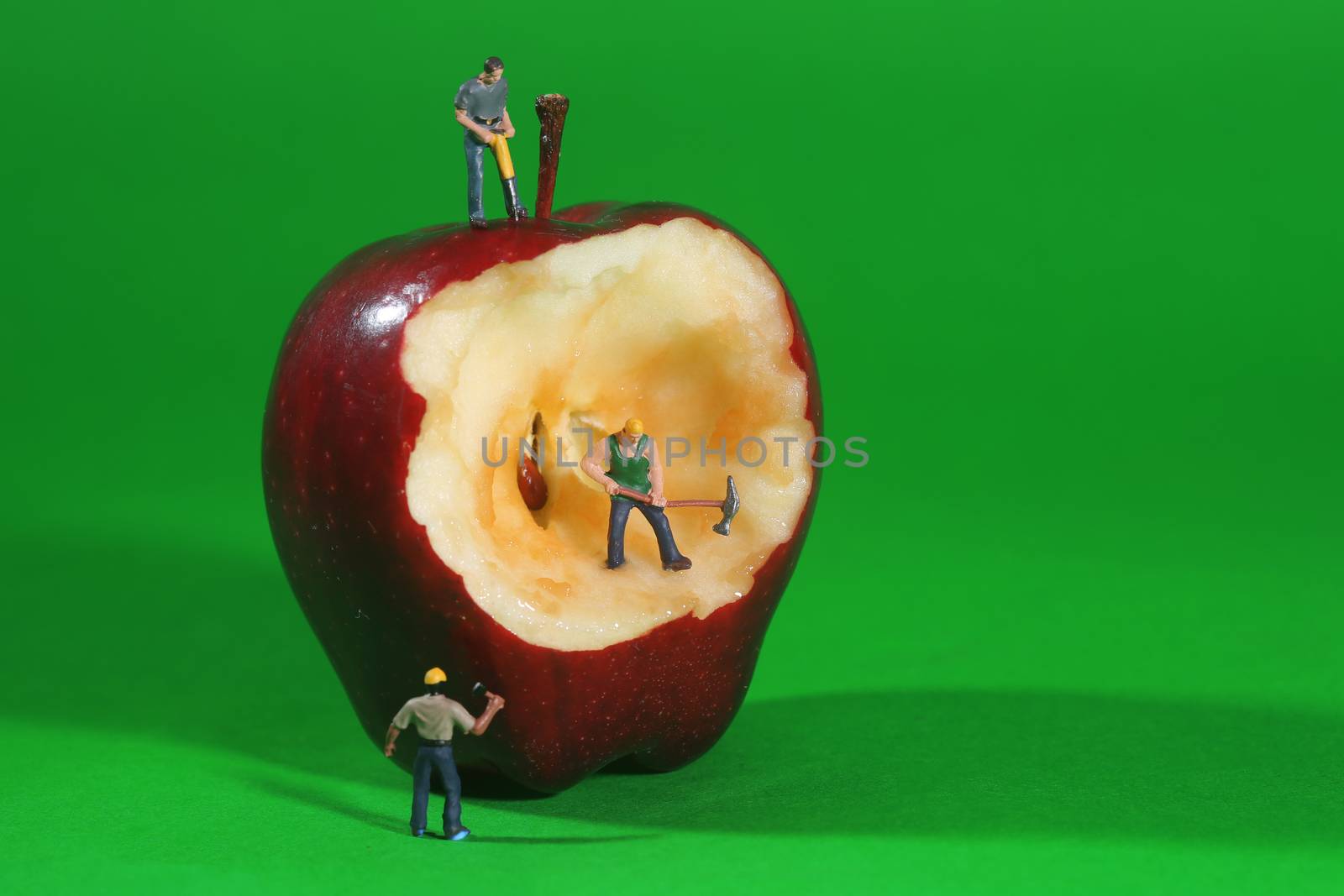 Miniature Construction Workers in Conceptual Imagery With an Apple