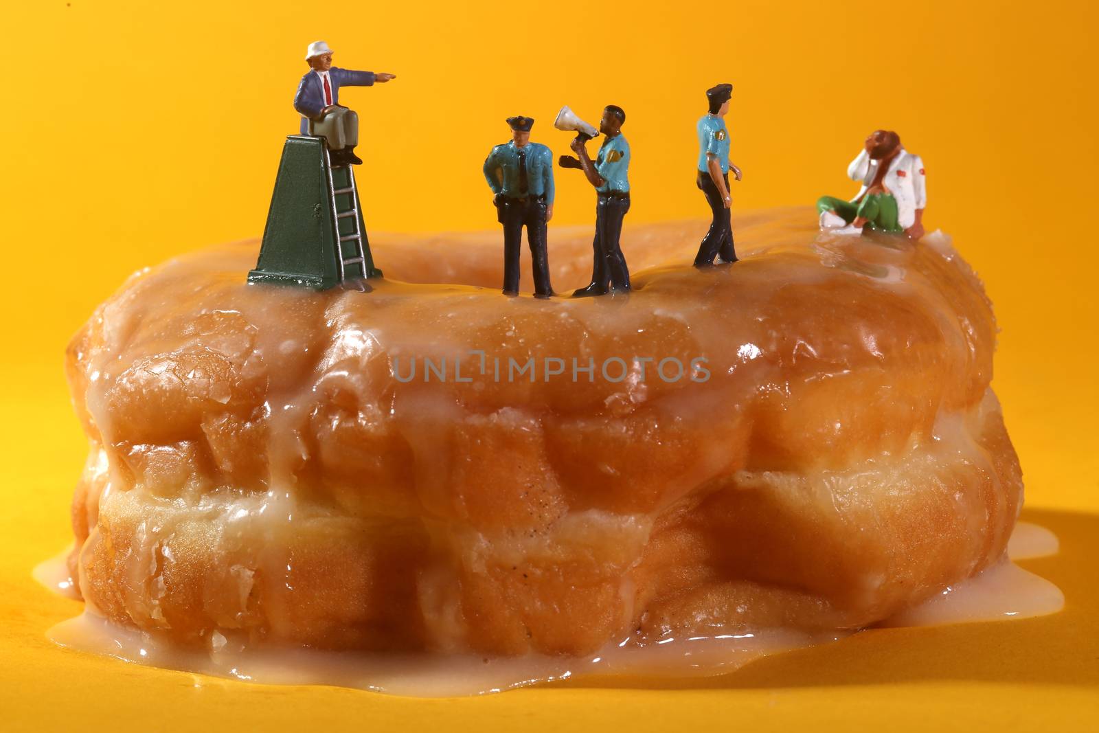 Miniature Police Officers in Conceptual Food Imagery With Donuts