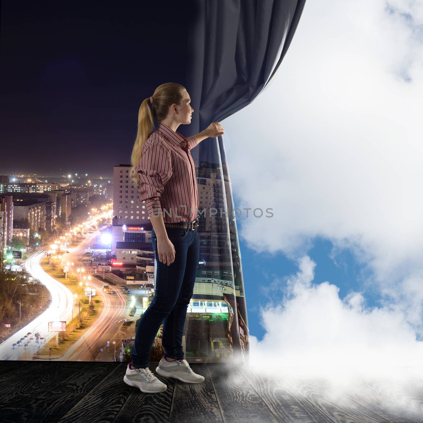 young woman pushes the curtain looking at clouds by adam121