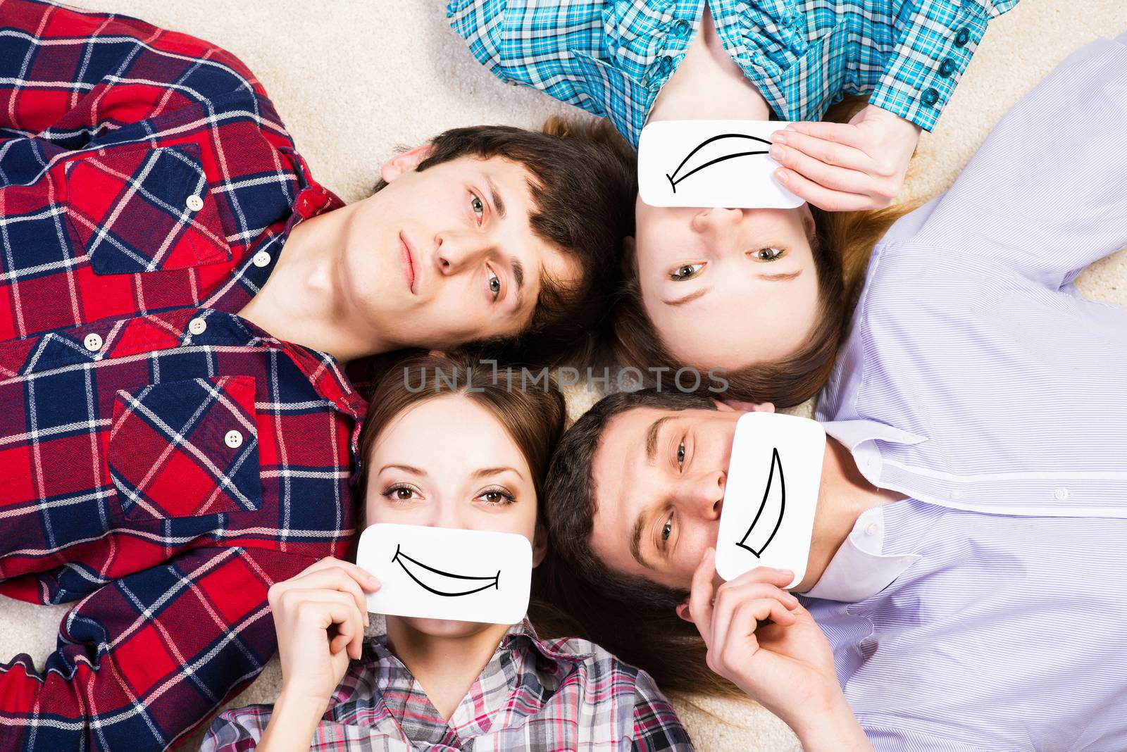 four young men lie together, applied to the face card with smiles