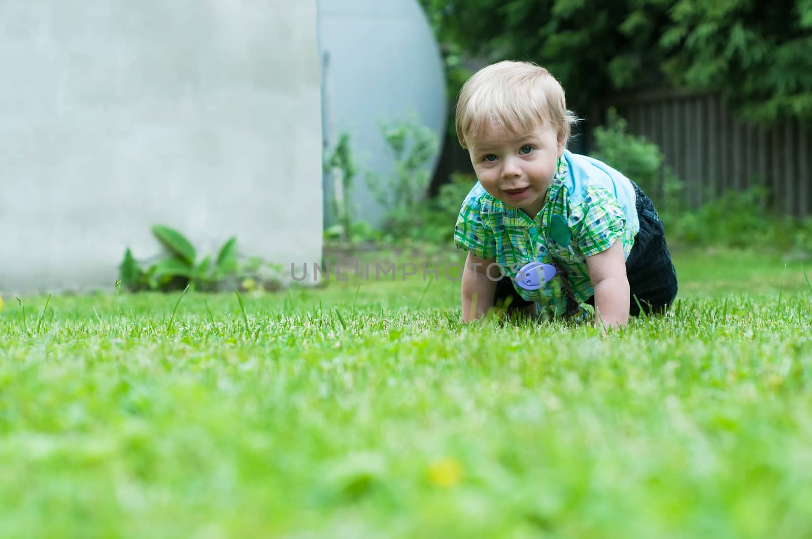 Shot of crawling baby boy on the green grass