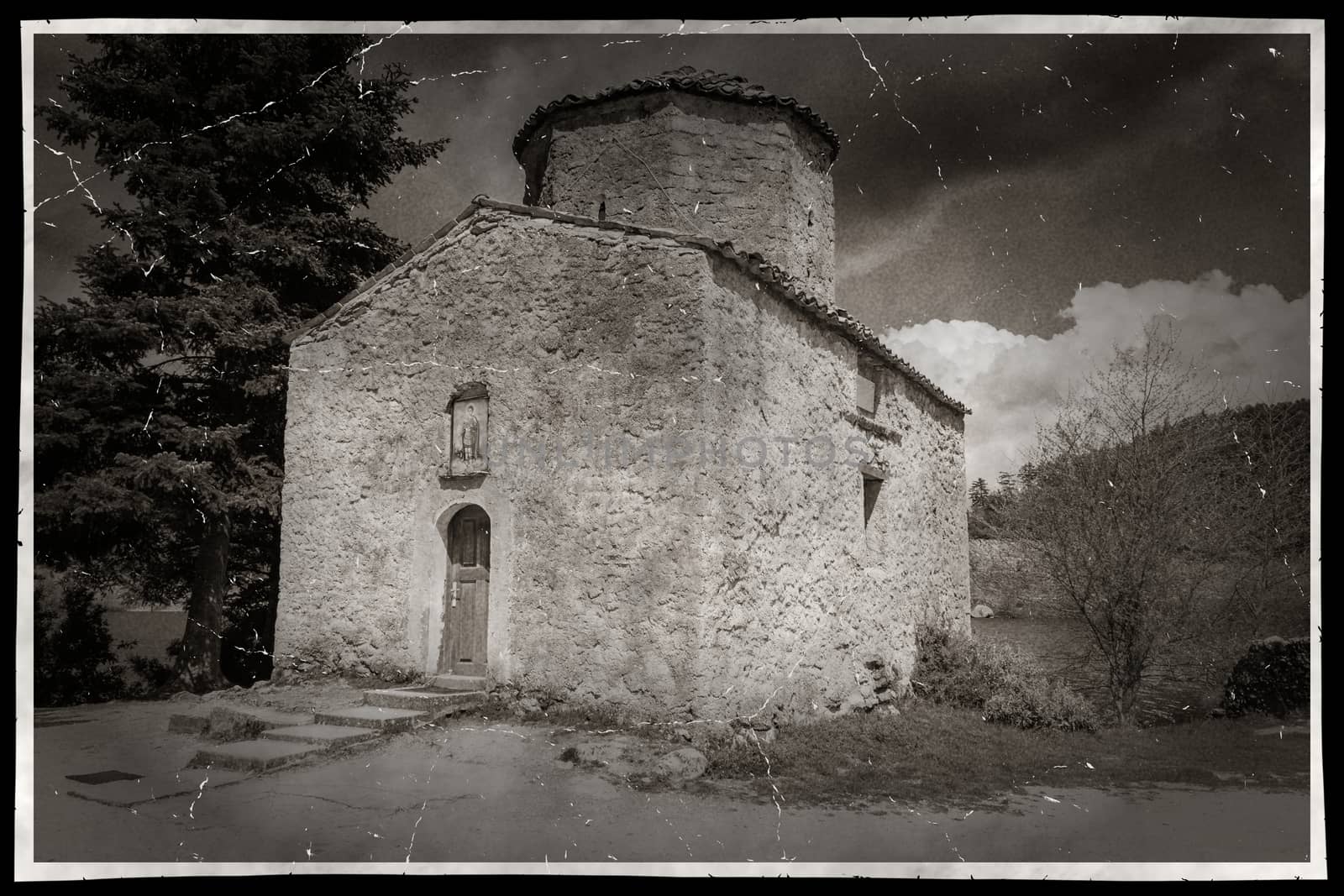 A damaged photo of an orthodox church in the nature