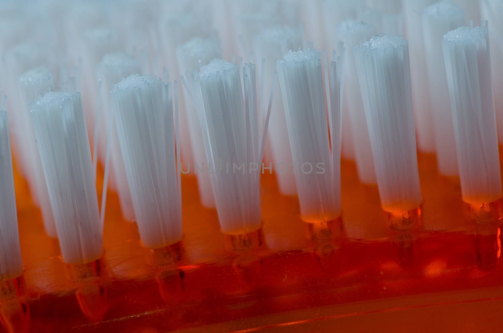 Brush with white bristles, closeup texture background