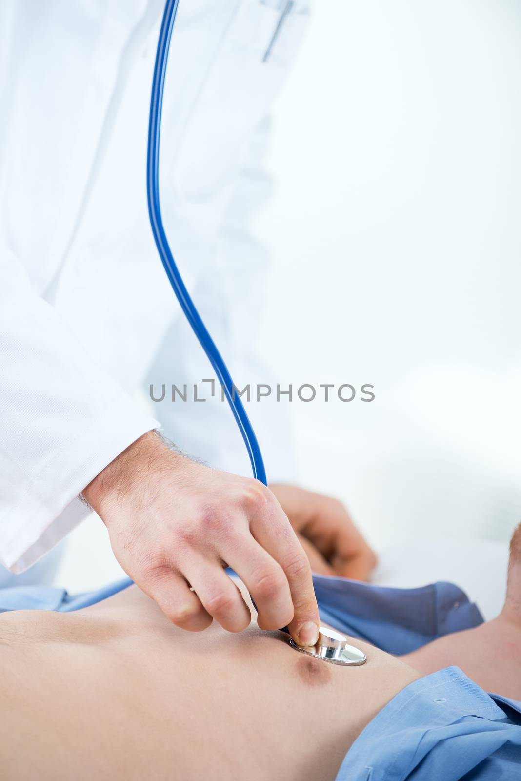 Doctor vising carefully a patient with a stethoscope. Close up