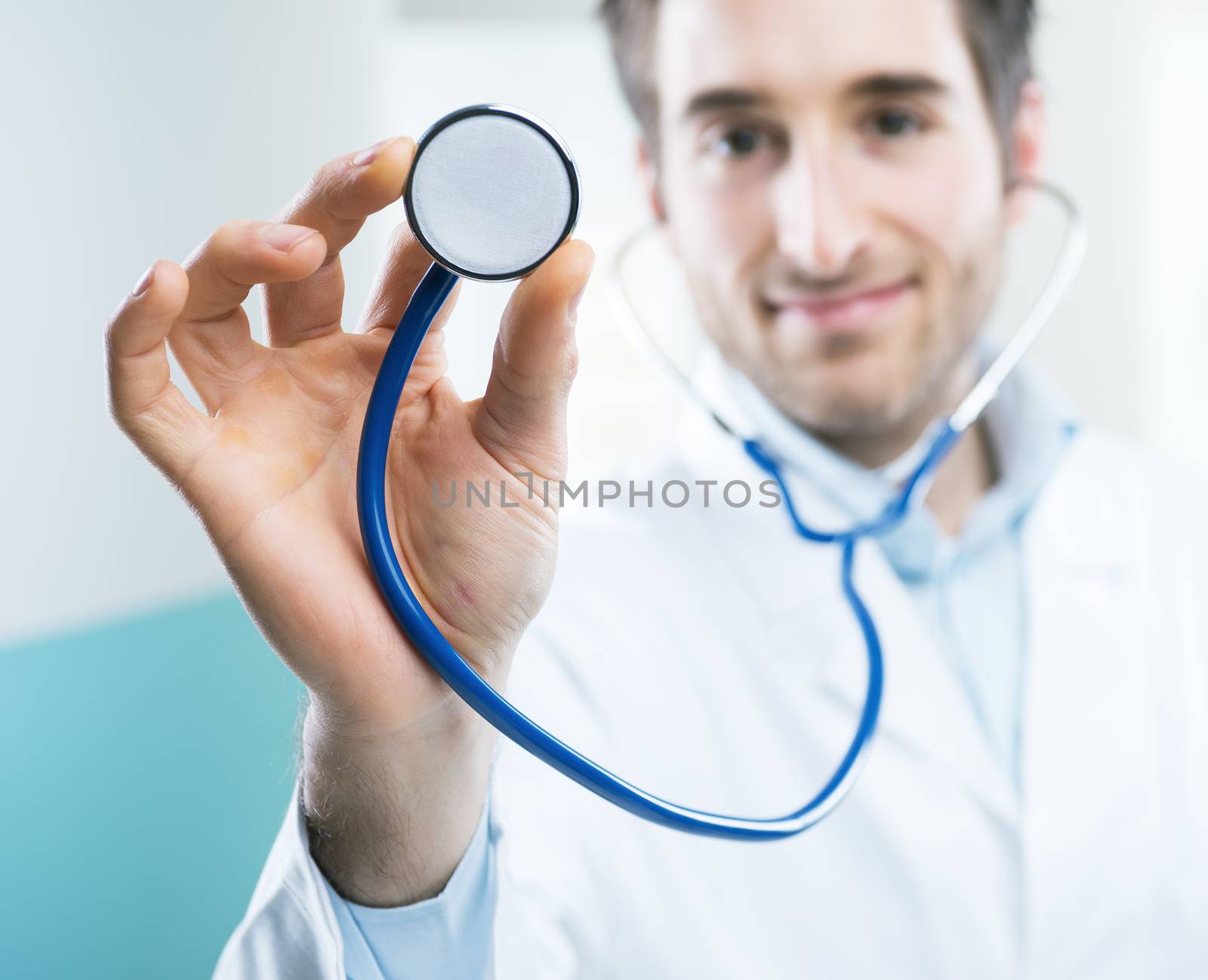 Young professional doctor at hospital with stethoscope