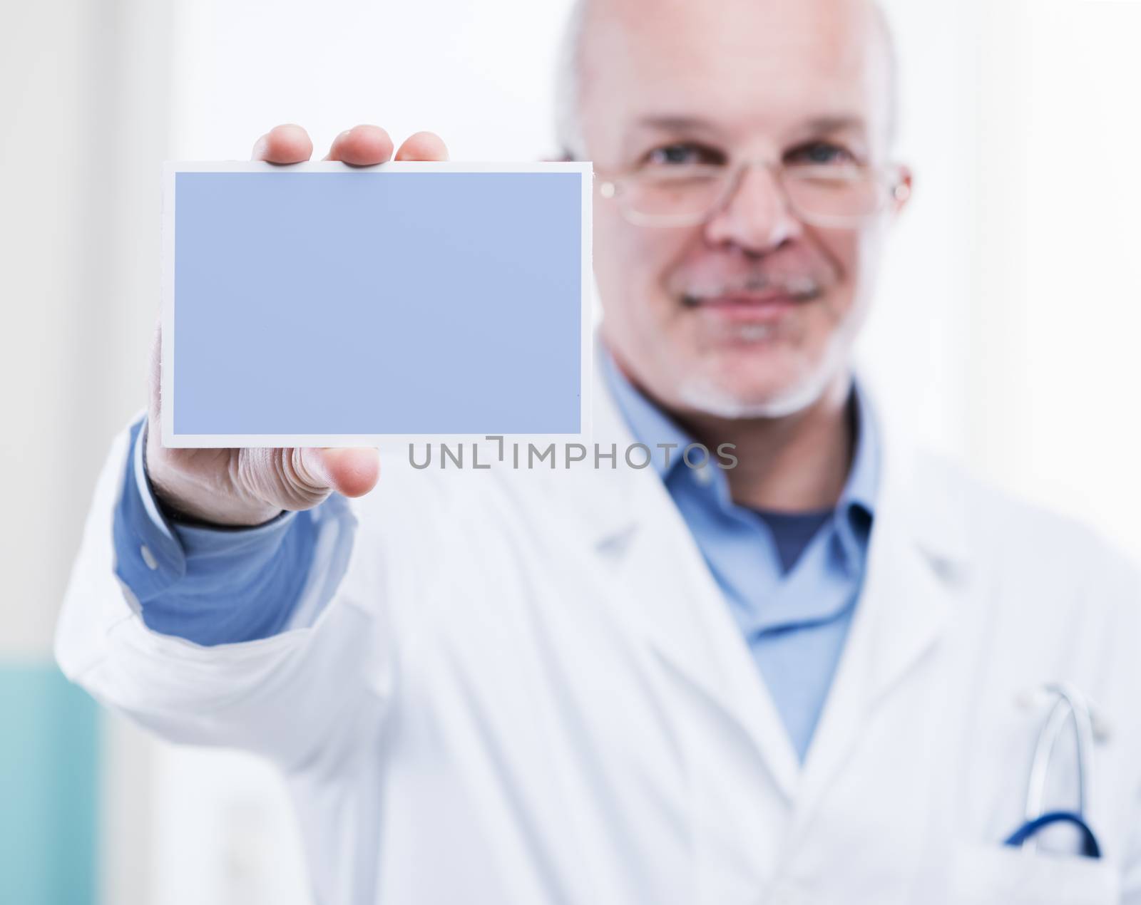 Doctor showing a small white sign, a custom message can be added.