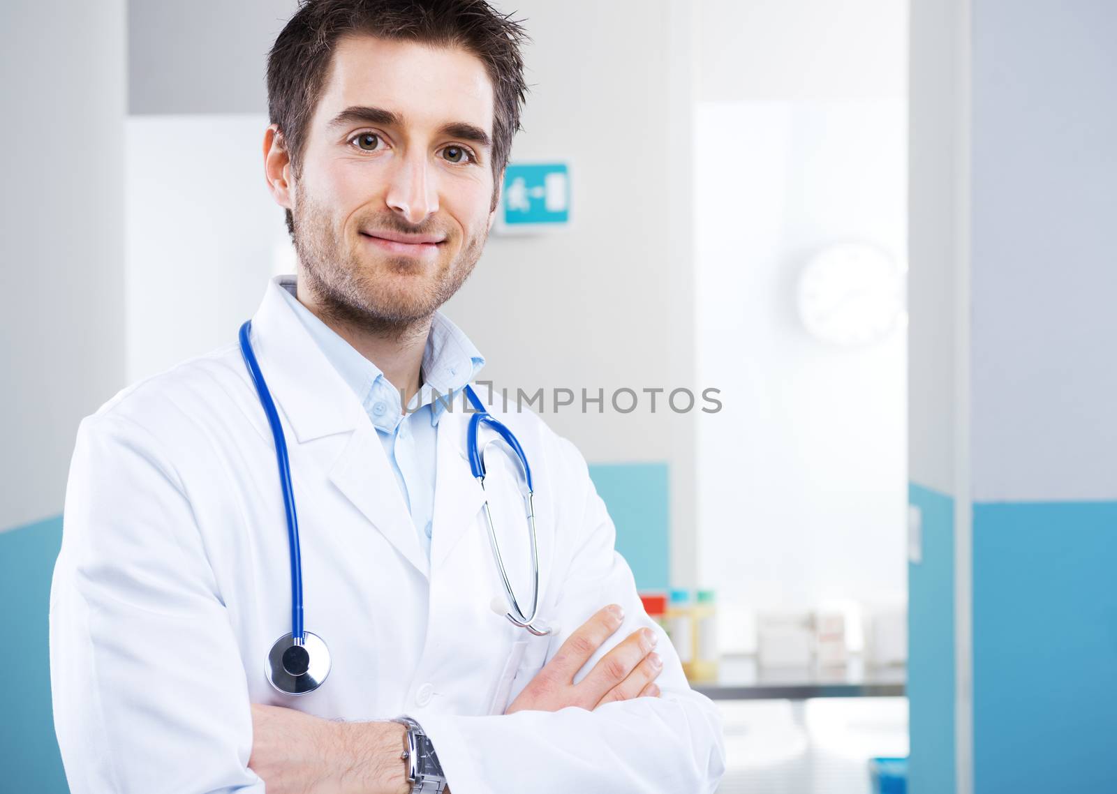 Young professional doctor at hospital with crossed arms