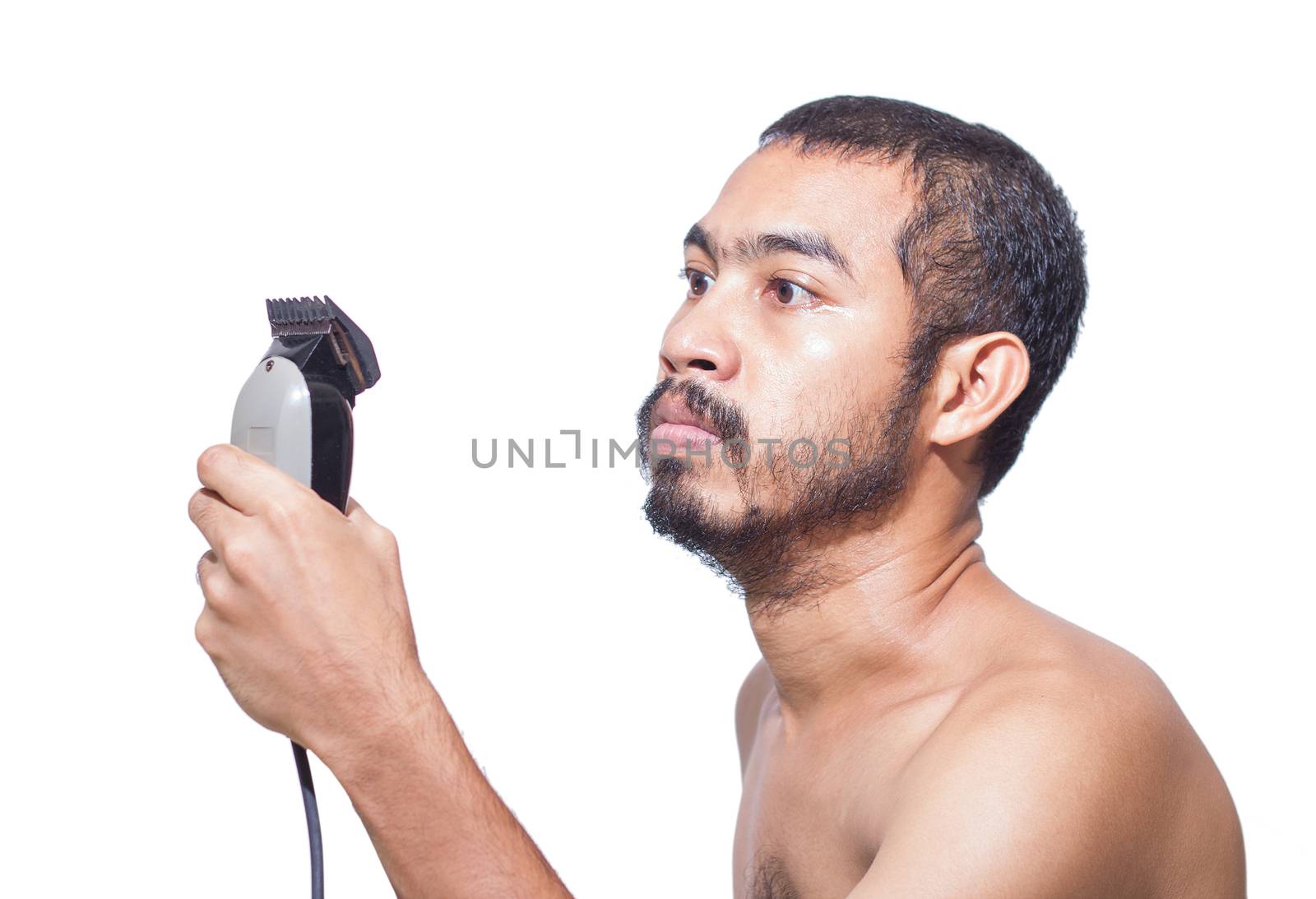 Asian man seriously hold hair clipper before cutting his hair by himself