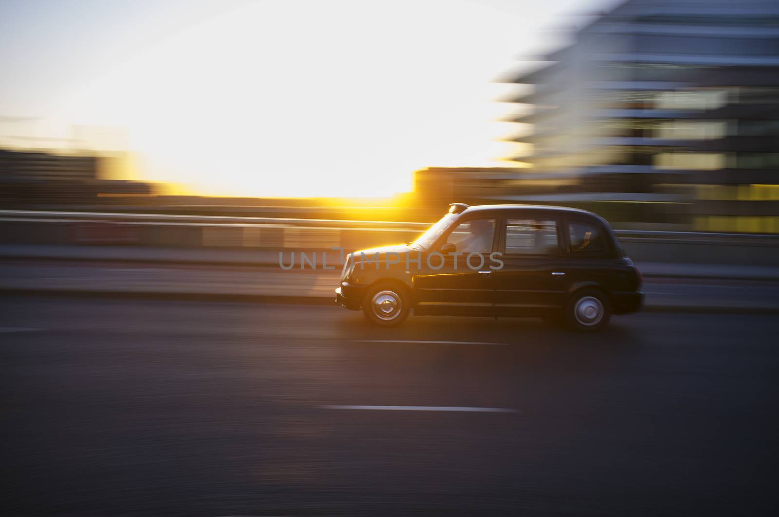 LONDON, UK – APRIL 16, 2014: London taxi driving on London Bridge.