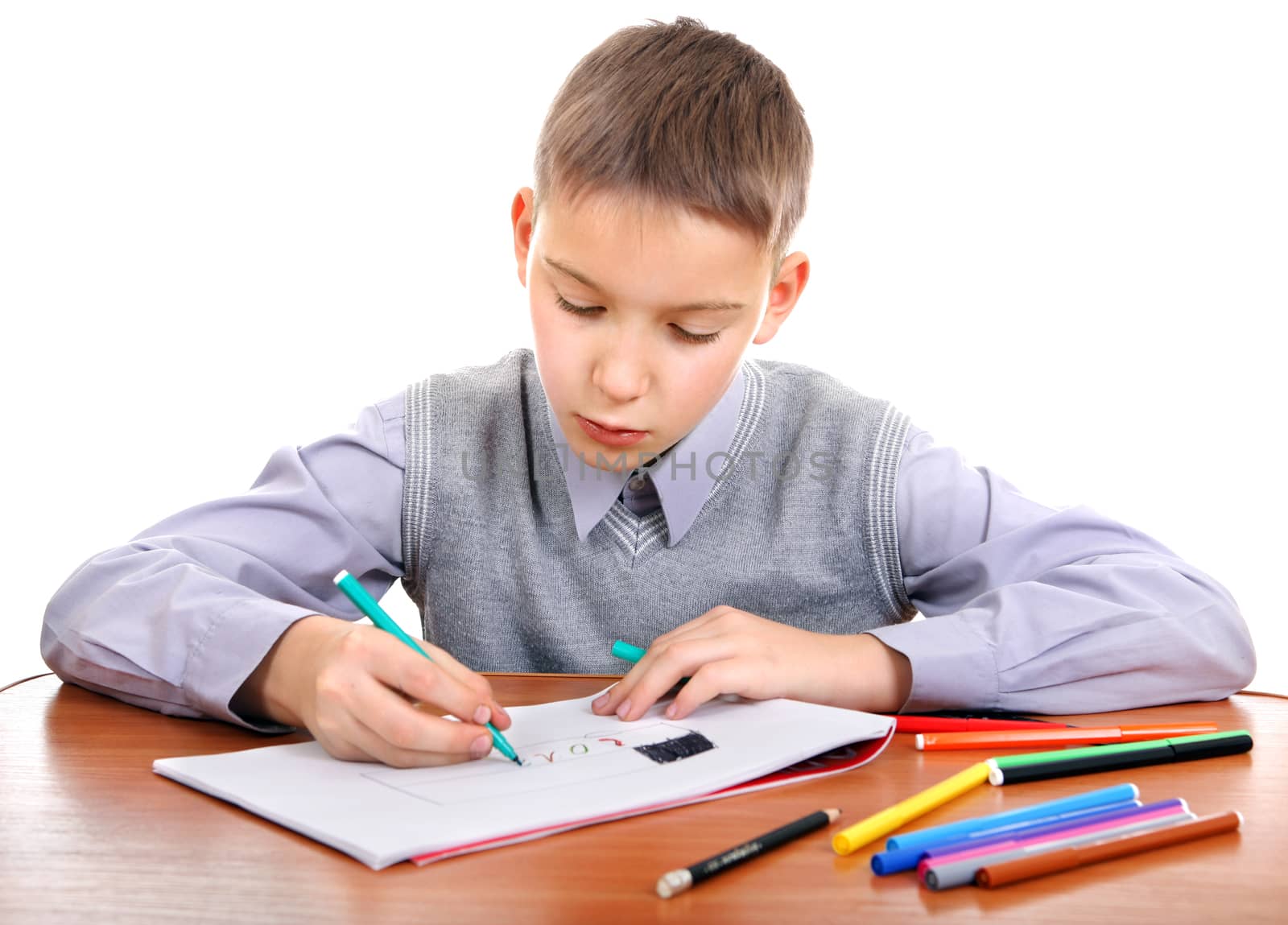 Cute Kid Drawing at the School Desk Isolated on the White Background