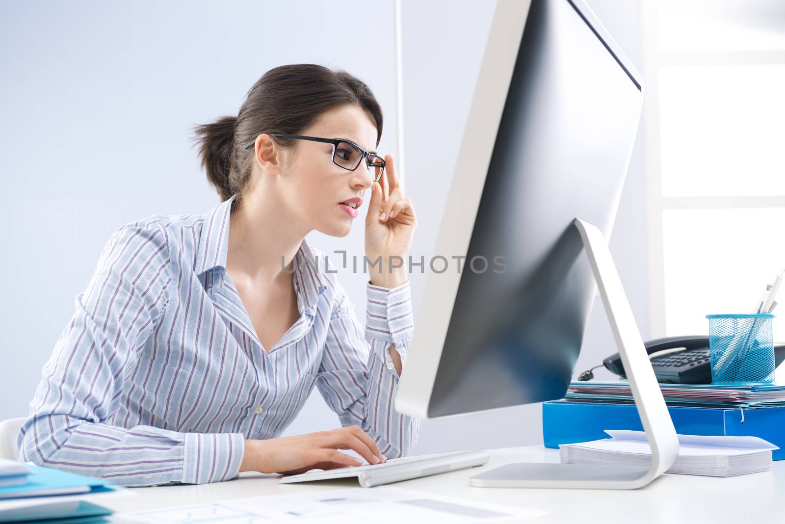 Office worker staring at computer screen by stokkete