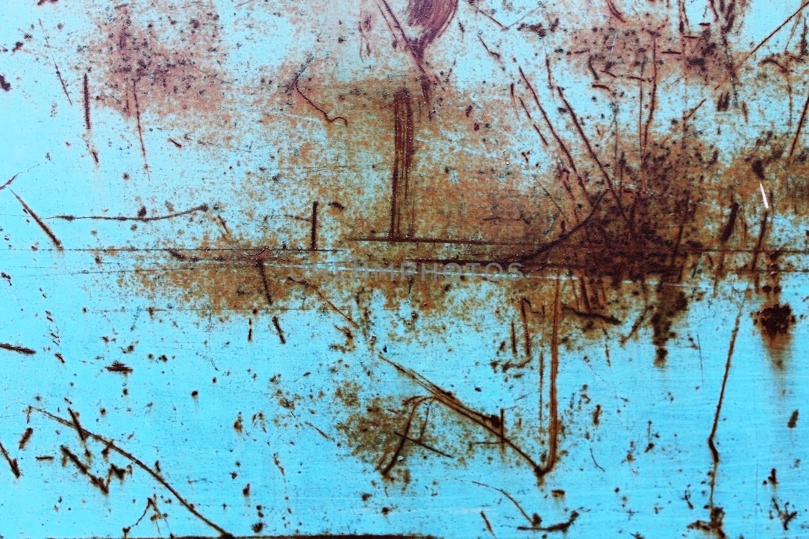 scratched the surface of a rusty blue background