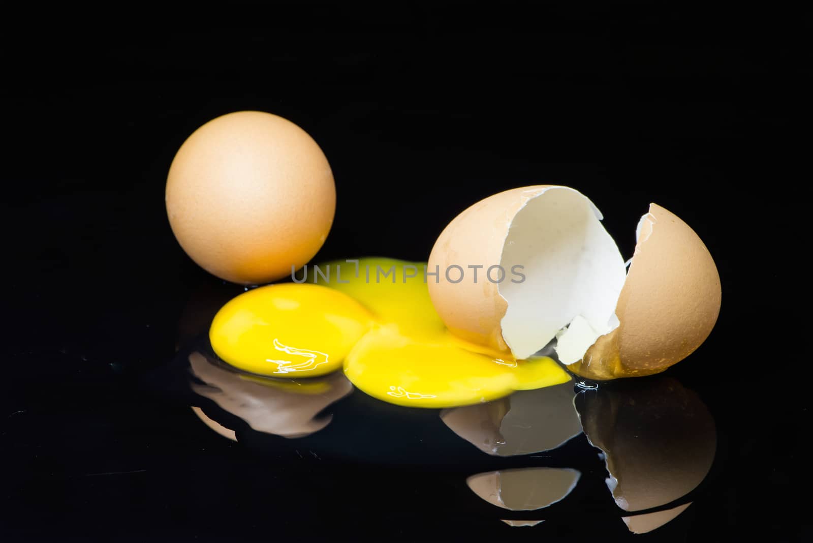 broken egg on a black background