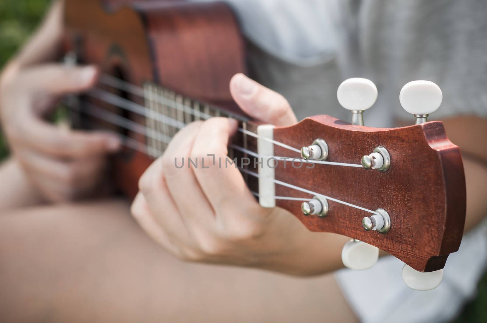 Hand playing guitar or ukulele