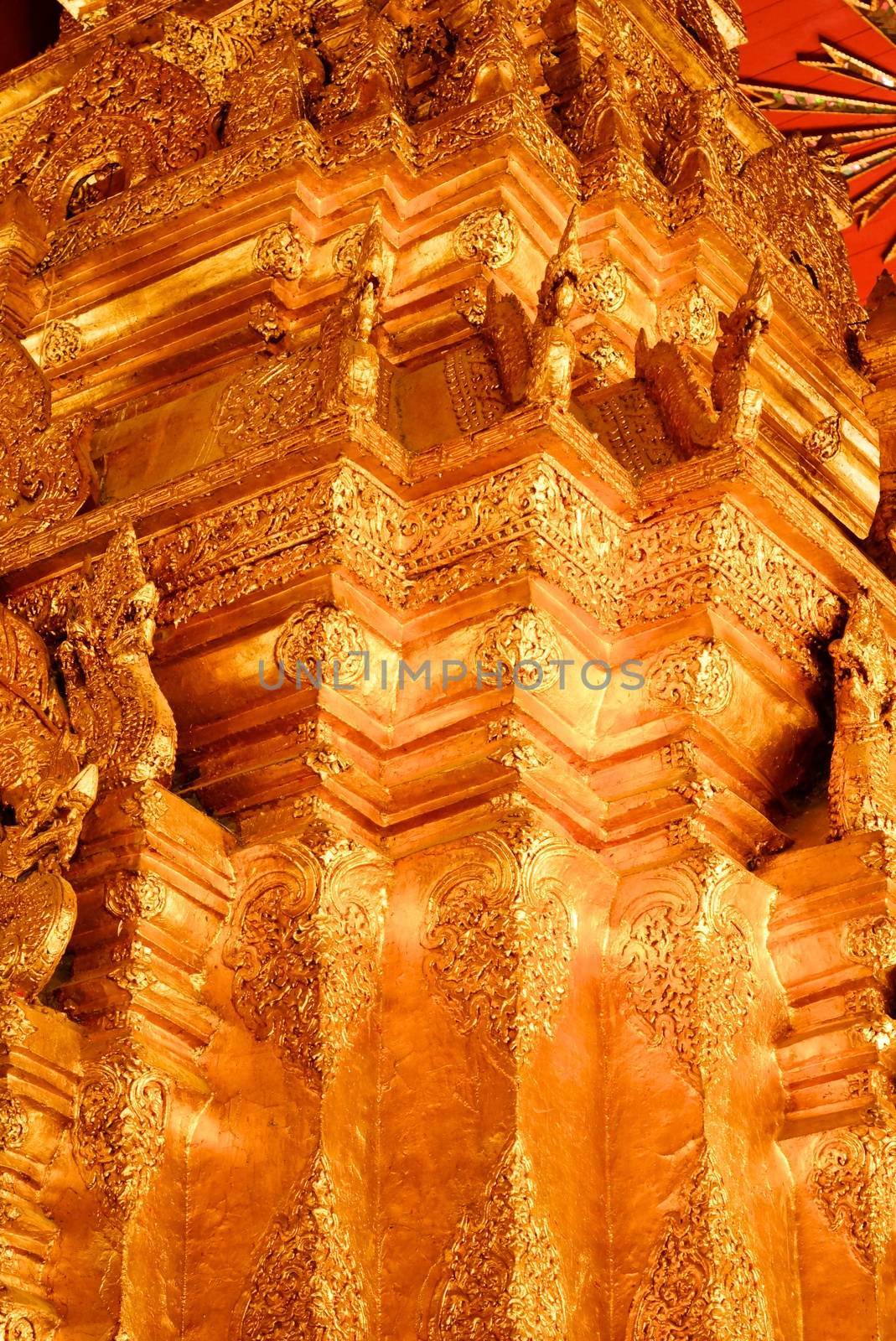 the high detail of square hall with pyramidal roof that made by real gold plate and decorated by craving thai pattern,Lampang temple,Thailand