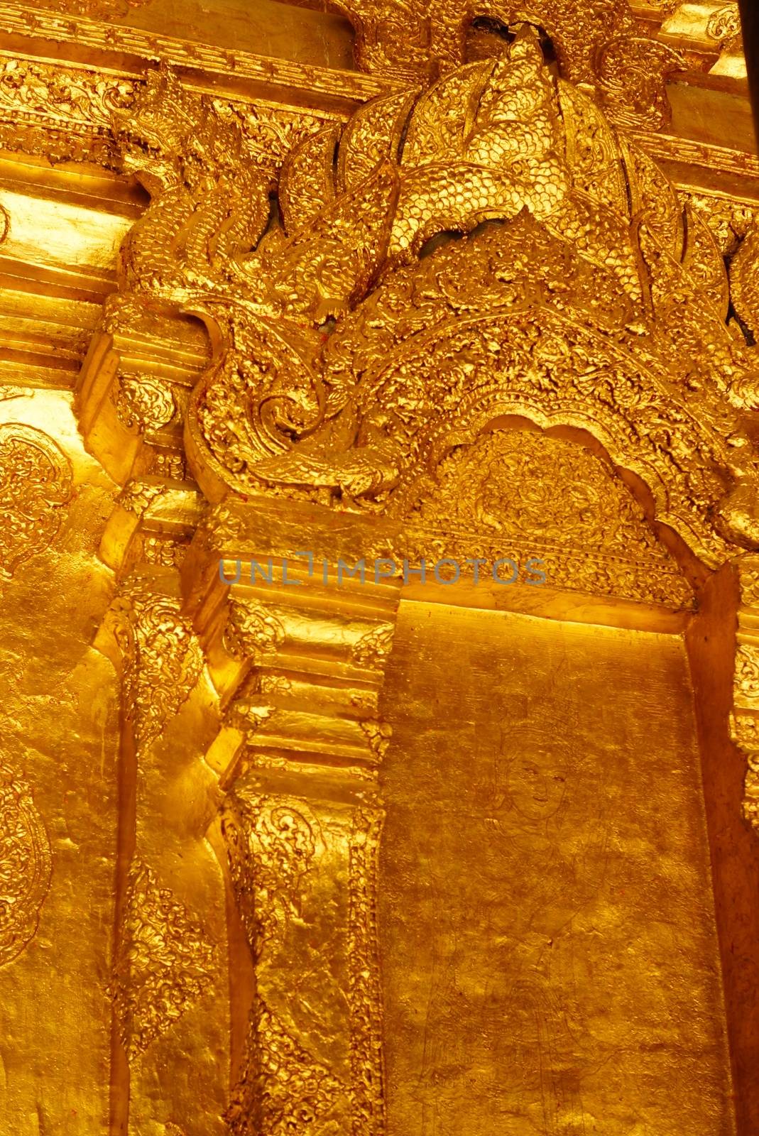 the high detail of square hall with pyramidal roof that made by real gold plate and decorated by craving thai pattern,Lampang temple,Thailand
